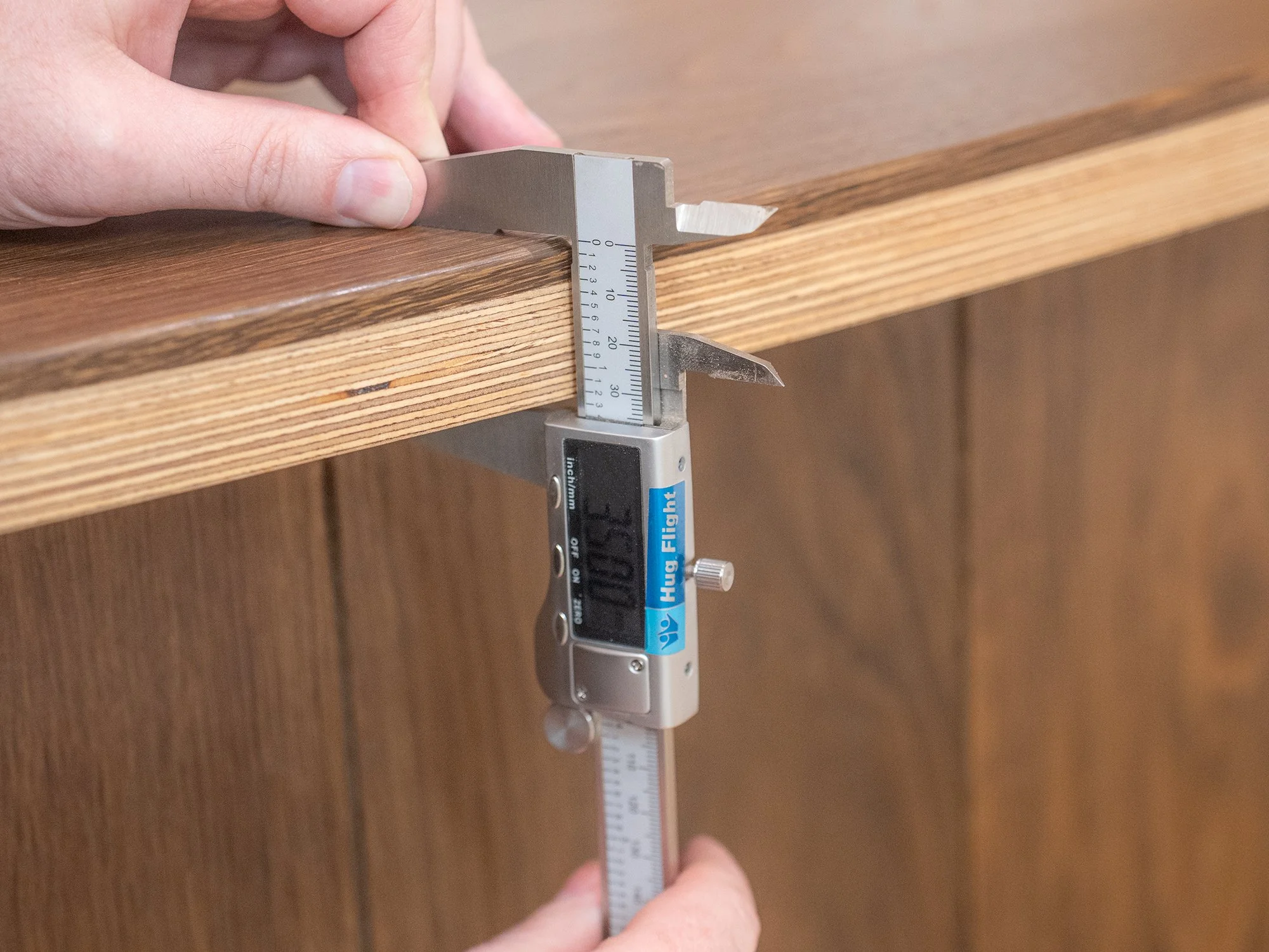 10mm wear layer wood flooring being measured with a vernier