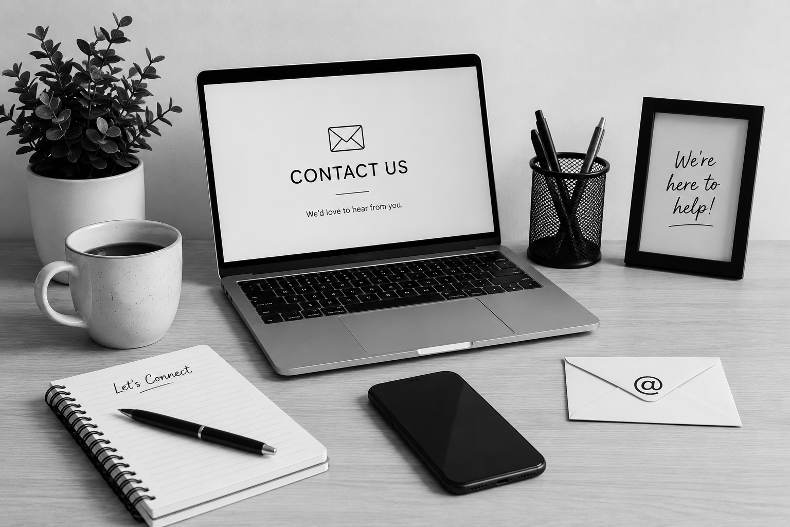 Contact desk setup with laptop, phone, notebook, coffee mug and stationery.