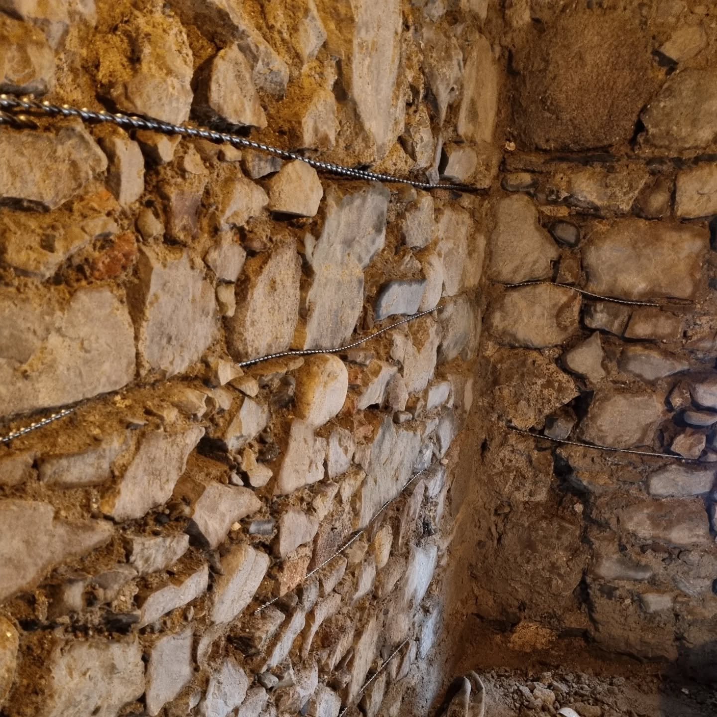 Centuries-old stone walls often carry the scars of time &mdash; hairline cracks, shifting joints, and sagging corners. By embedding Helibars within the repointing work, we give the wall invisible strength. The character remains untouched, but the str