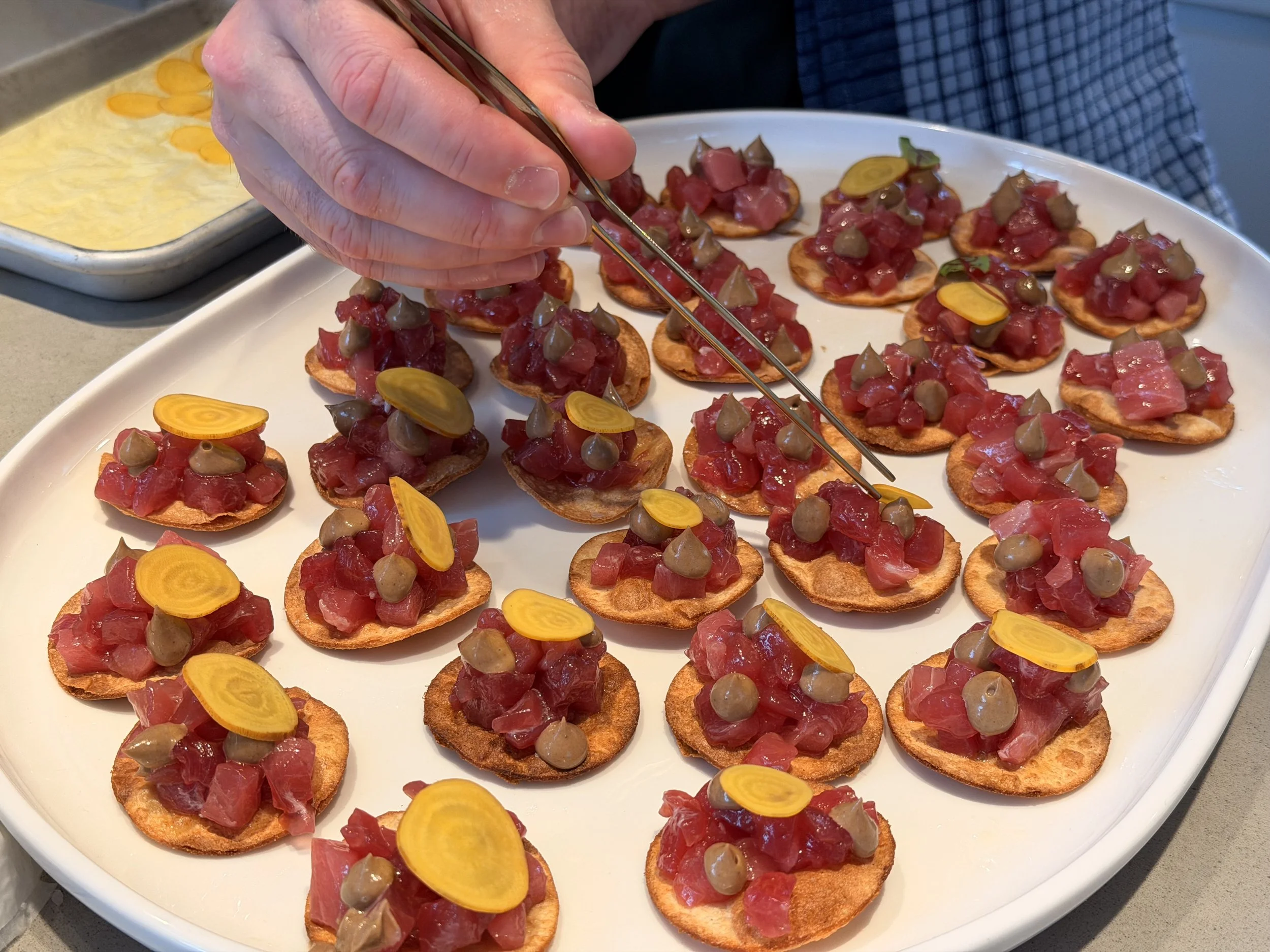 Canapé event service, plating yellowfin tuna tostadas. Bespoke events and private dining in North Melbourne.