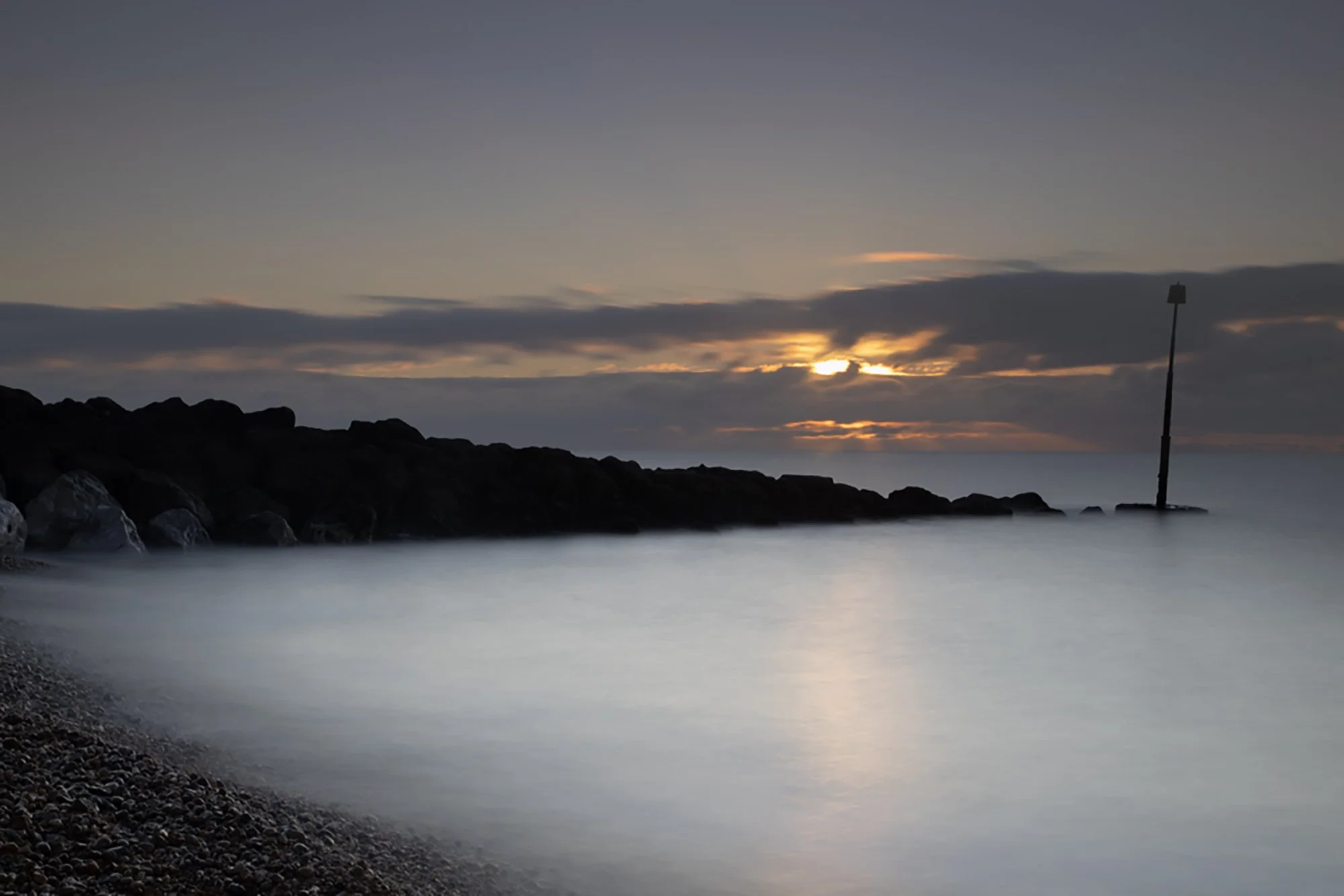 25 second exposure of the Sunrise over a rock groyne at Hythe Kent