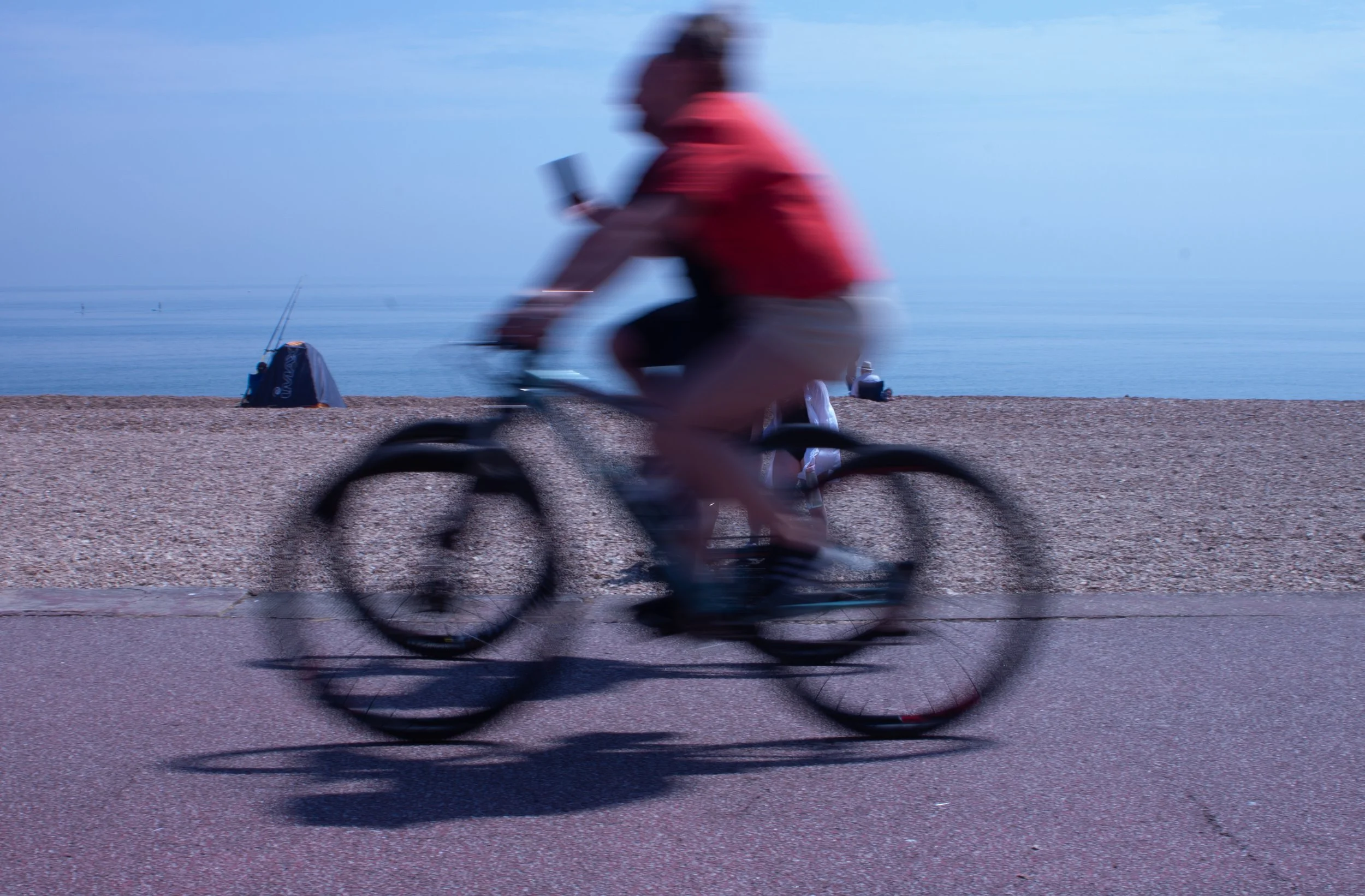Fast cyclists, slow shutter on Hythe beach, Kent