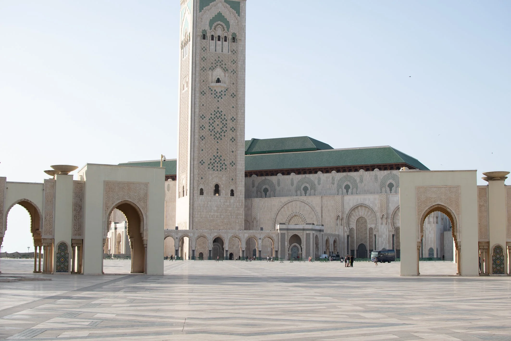 La mezquita Hassan en Rabat, Marruecos, con sus puertas arcos y su minarete alto en el centro, en una tarde soleada.