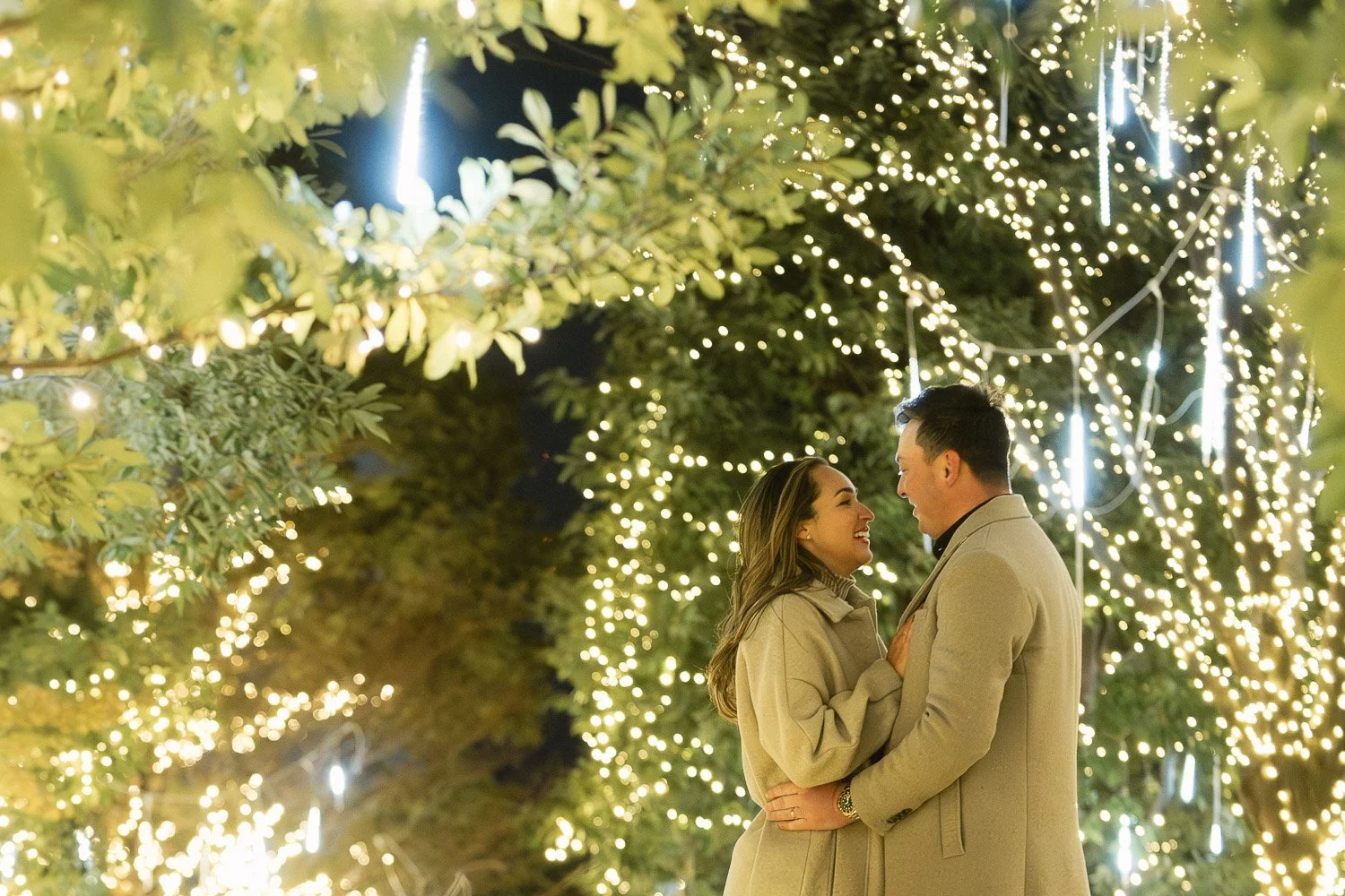A married couple embraces beneath the winter illuminations in Tokyo