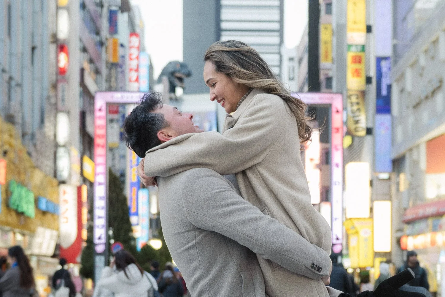 A married couple have a romantic moment in front of Godzilla in Tokyo