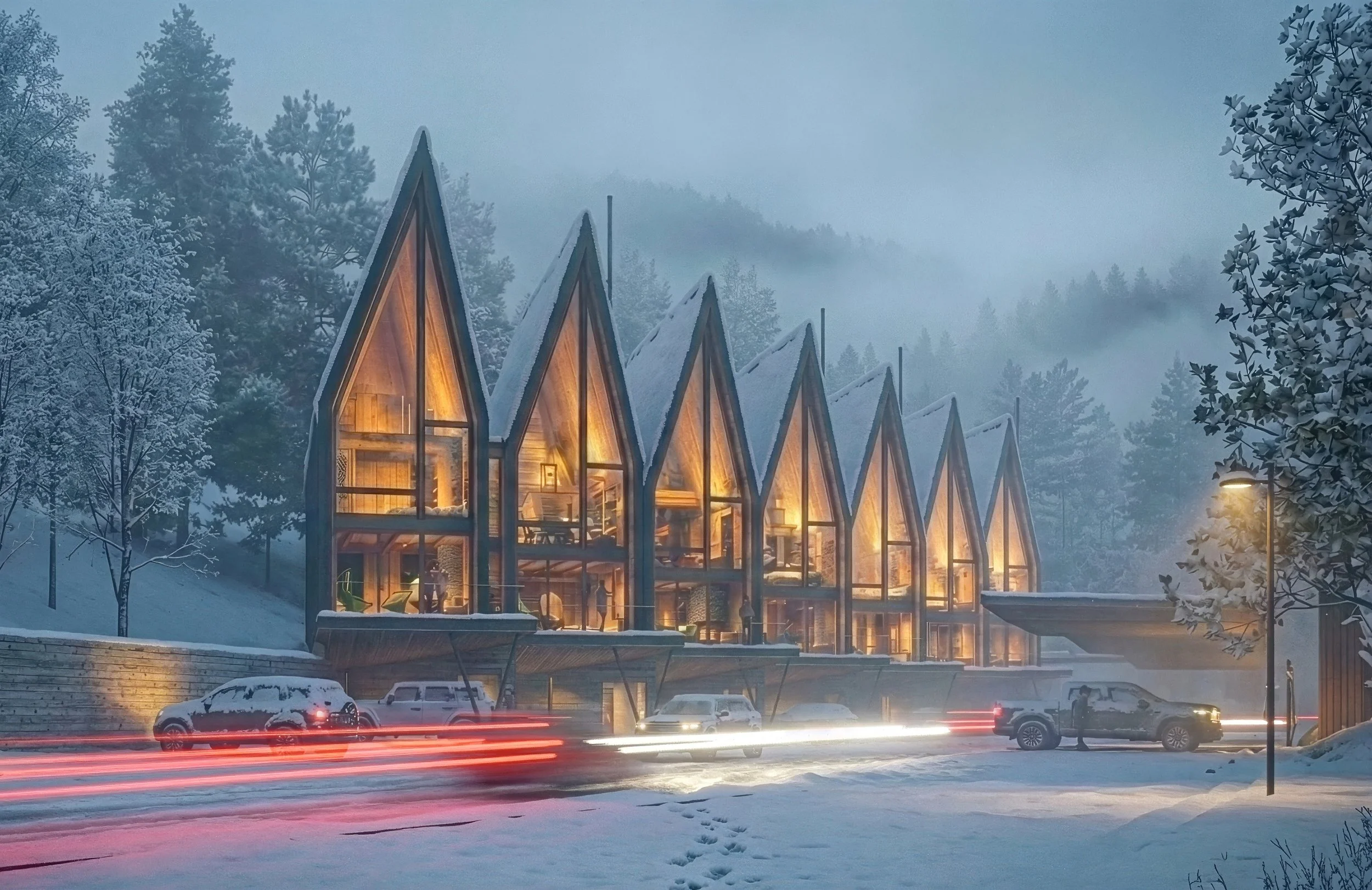 A modern building with large glass windows and a unique pointed roof design, situated in a mountainous area with trees and mist. Cars are parked outside, and there are people near the entrance, under streetlights at dusk.