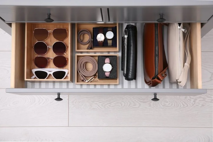 Custom accessory drawer organization for watches, sunglasses, and belts in a Boston home