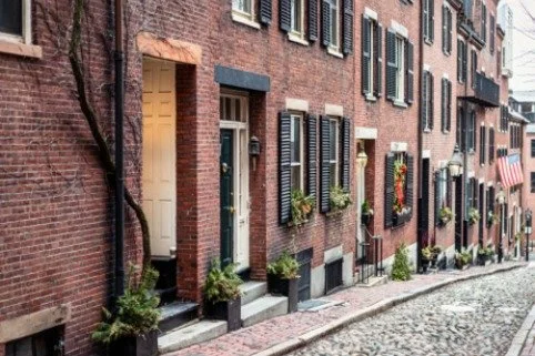 Cobblestone street lined with historic brick homes in Beacon Hill, Boston