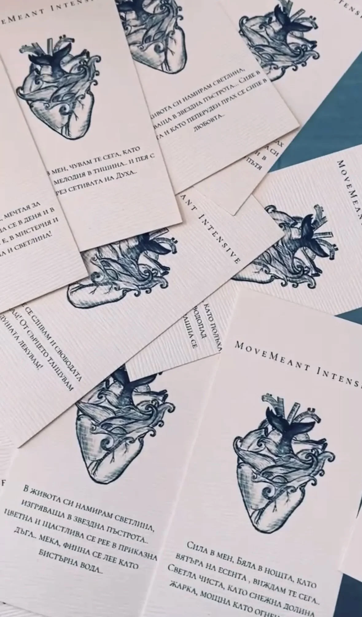 Several pink cards with a blue anatomical drawing of a human heart and text in Bulgarian and English, reading "MOVEMENT INTENSIVE".