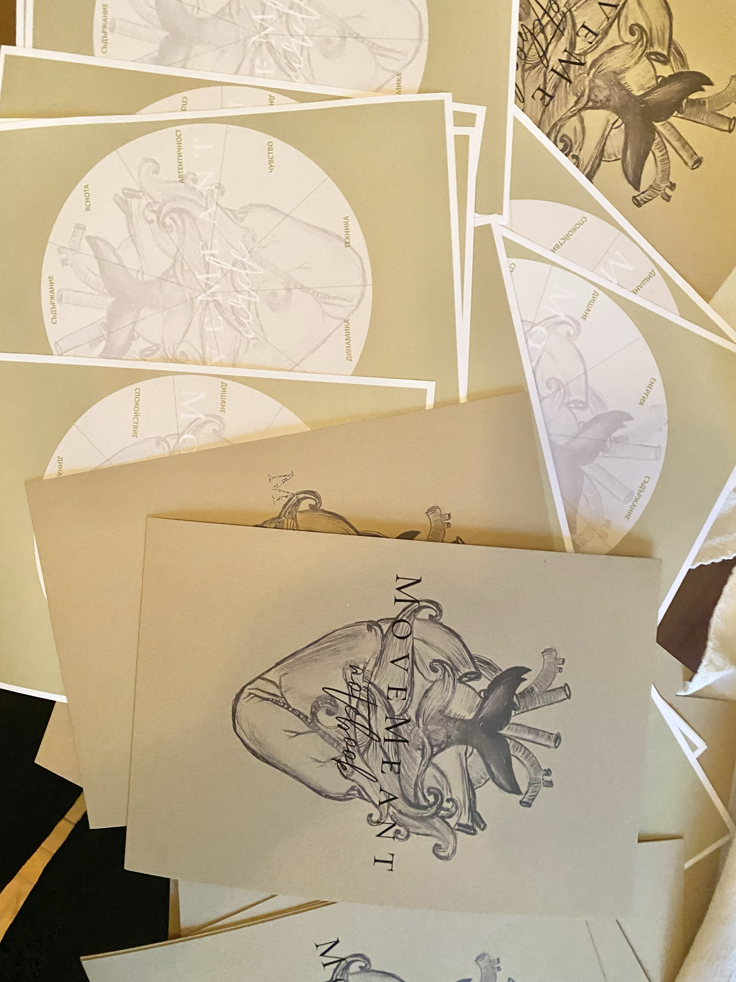A collection of printed materials, featuring drawings of a human heart with a ribbon and text, some printed in serif font and some in cursive.