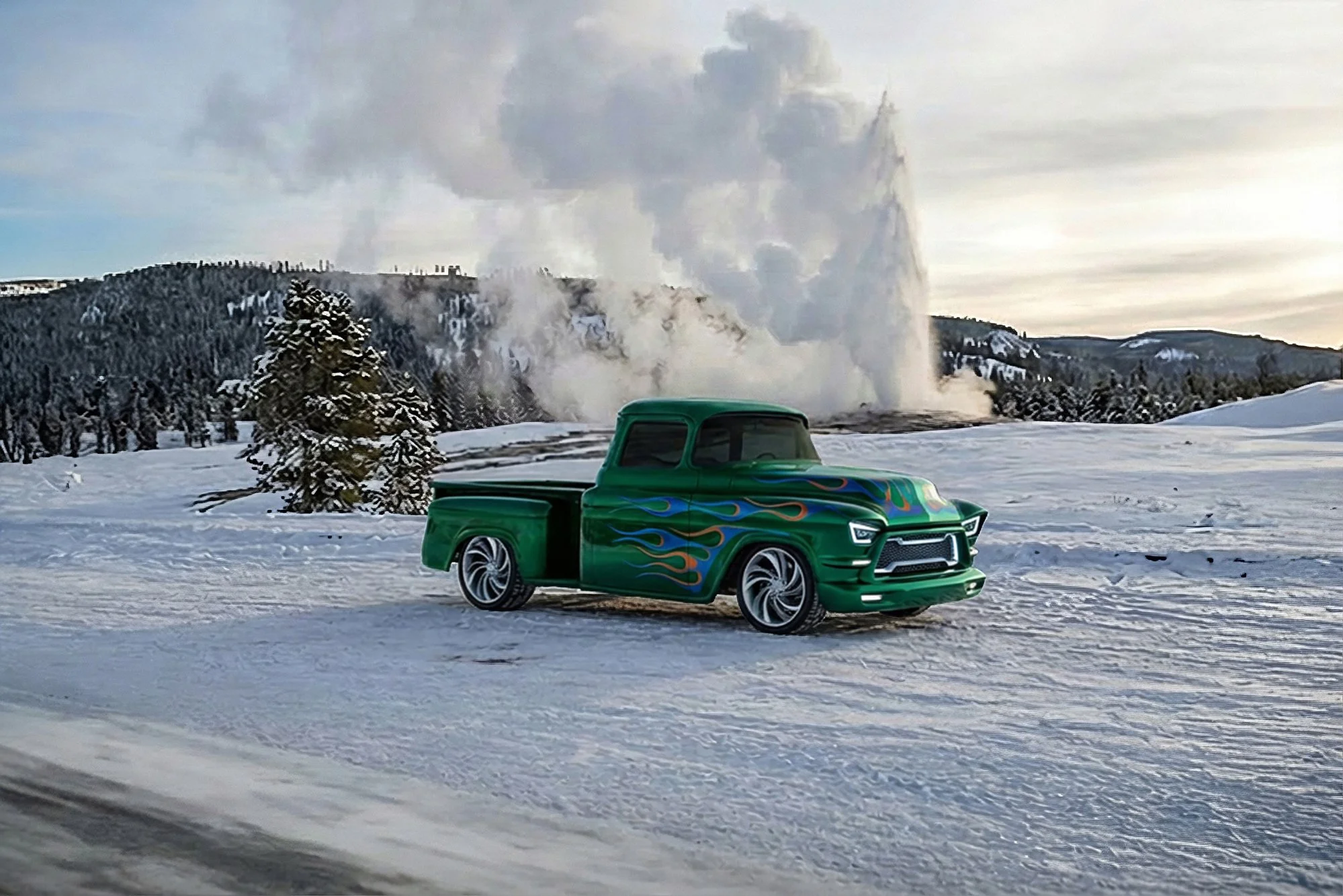 A toy model truck with a green body and flame decals parked on snow in a winter landscape with snow-covered trees and mountains. Steam or smoke rises in the background.