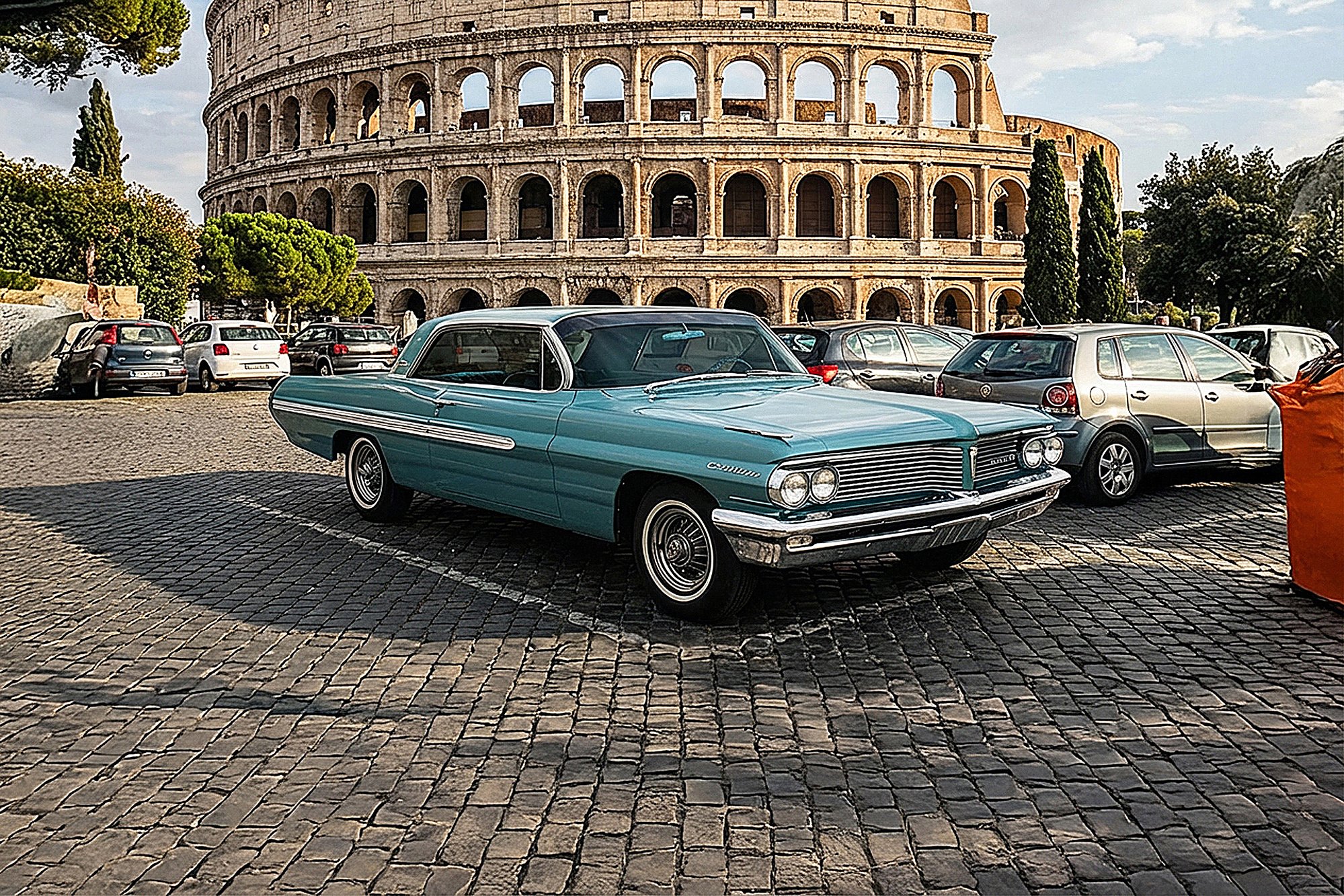 A shiny vintage teal car parked on cobblestone street with the Roman Colosseum in the background, surrounded by trees and other parked cars.