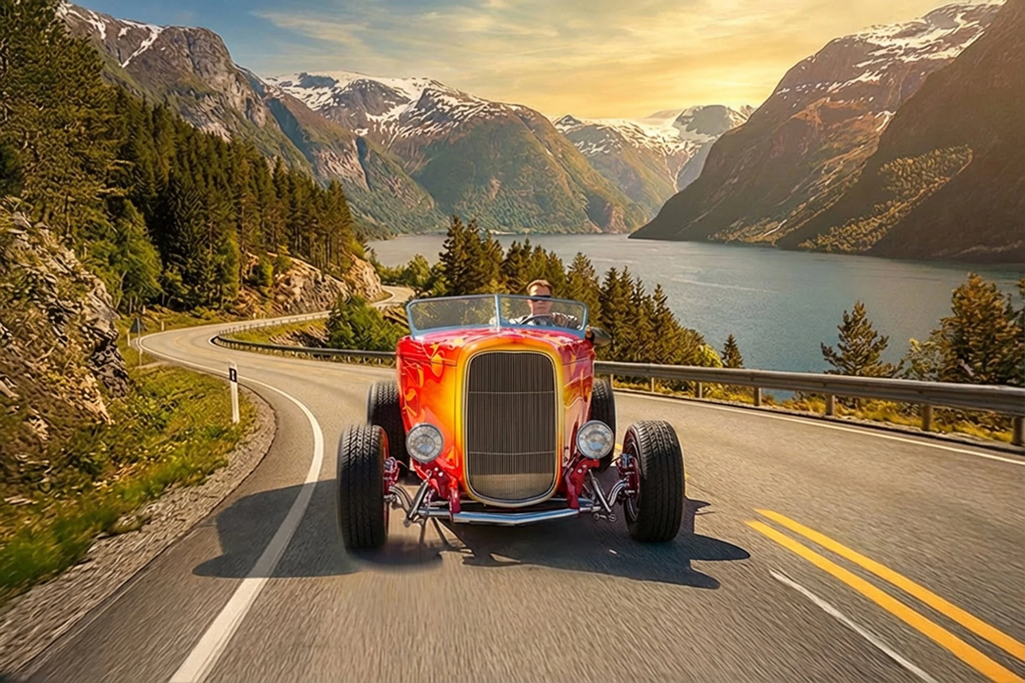 A red vintage convertible car driving along a winding mountain road with snow-capped peaks in the background and a lake reflecting the sky, during sunset.