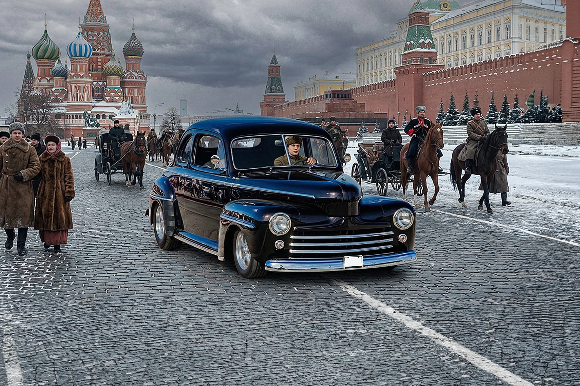 A historic scene with a black vintage car and people dressed in old-fashioned winter clothing walking and riding horses on a cobblestone street in front of a Russian-style kremlin with colorful onion domes and red brick walls, under a cloudy sky.