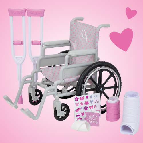 Dolls grey plastic wheelchair, crutches, ankle cast, arm cast, get well soon card and sticker sheet, displayed on a light pink background.