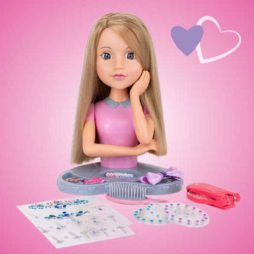 Plastic doll styling head with blonde hair, gem sticker sheet, hair accessories and hair brush, displayed on a pink background.