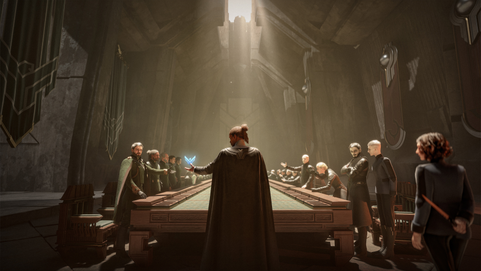 A futuristic, dimly lit room with a large rectangular table. A woman in a dark cloak stands at the center, facing a group of people seated around the table who are reaching out towards her, with one person holding a blue glowing object. The room has a high ceiling with elaborate architecture and panels on the walls.