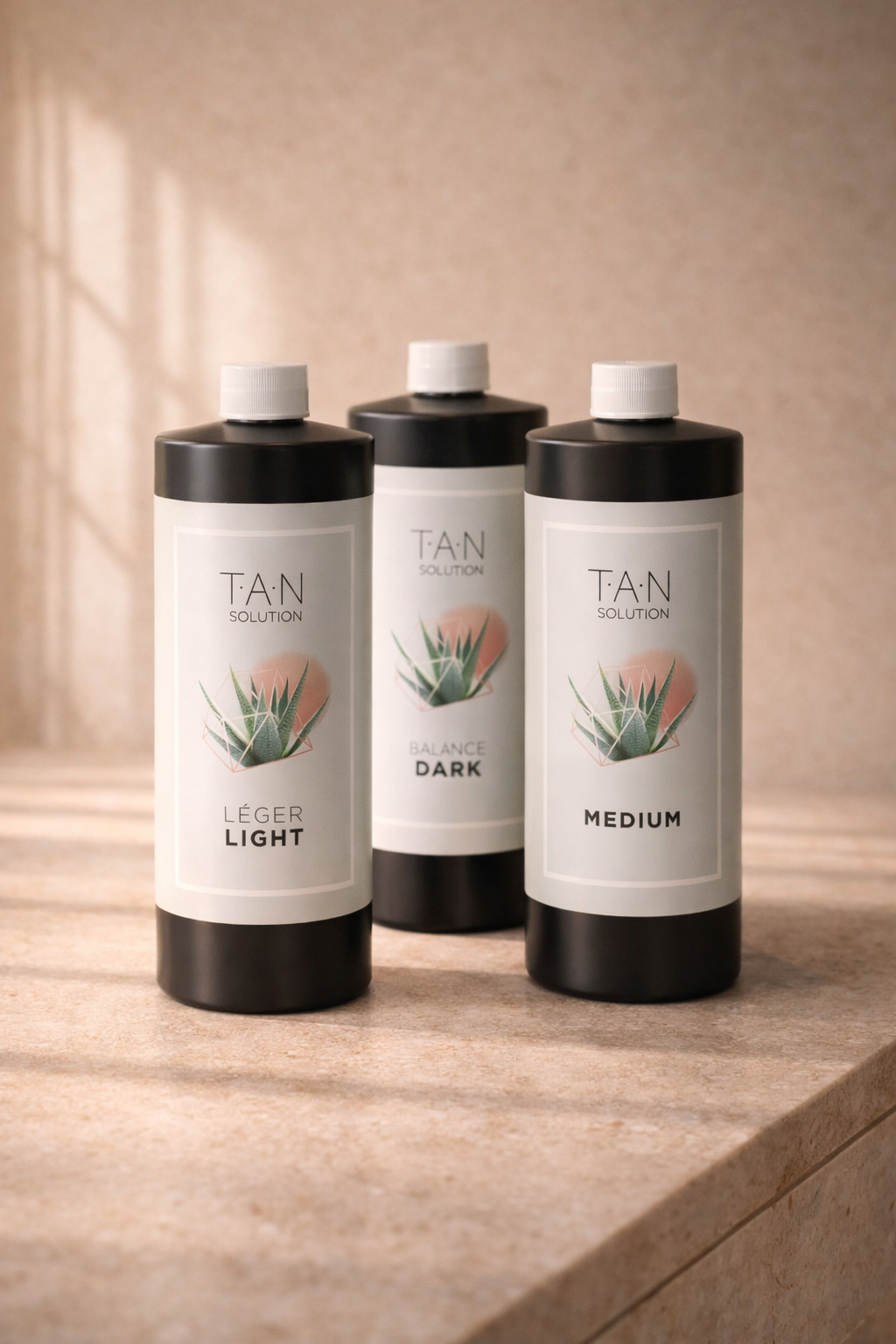 TAN Naples spray tan solution bottles featuring aloe-based, skin-loving formulas