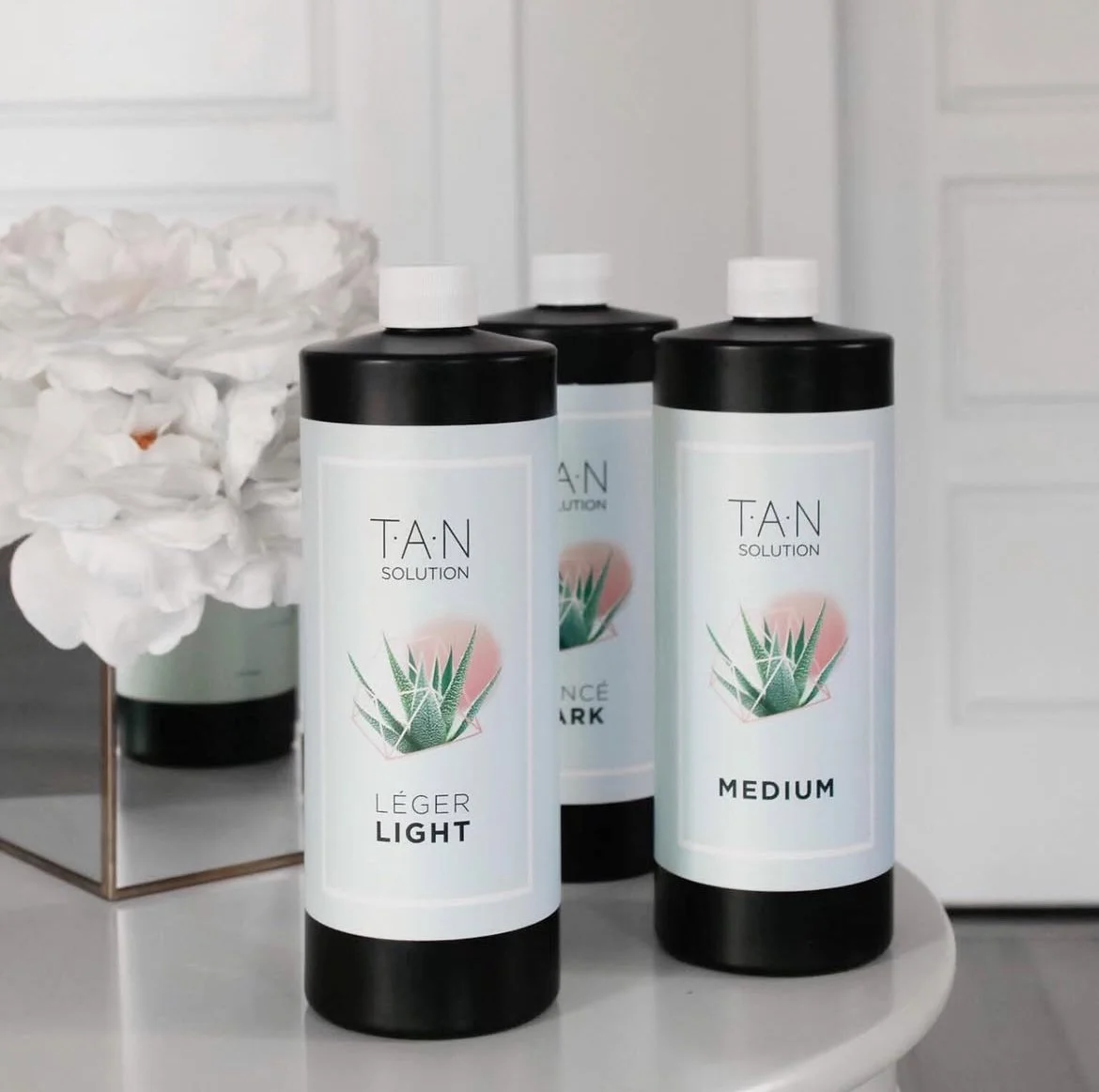 Sunless tanning lotion trio | Light, Medium, Dark shades | Custom spray tan formulas by TAN Naples, Florida