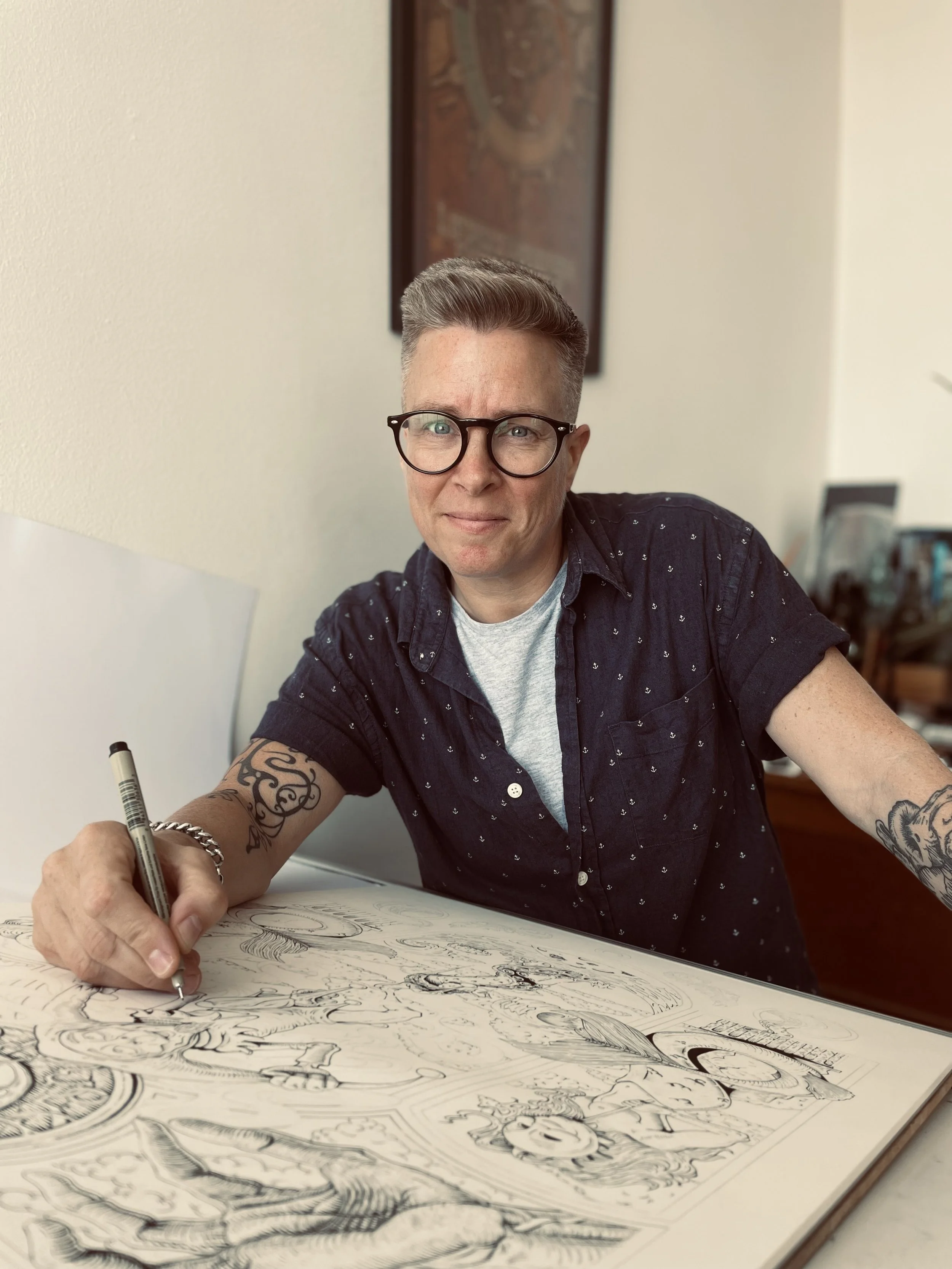 Person drawing intricate sketches in a large sketchbook at a table.