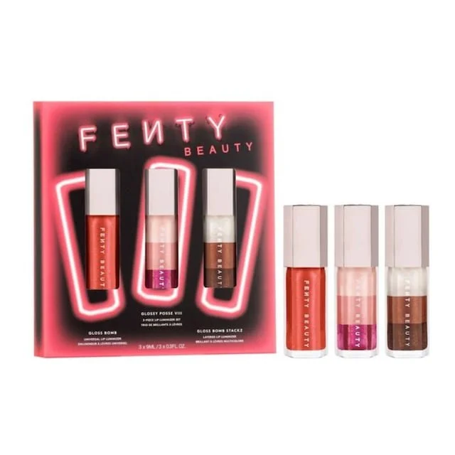 Set of four Fenty Beauty glosses in transparent bottles with white caps, displayed with a promotional card showing three additional gloss shades.