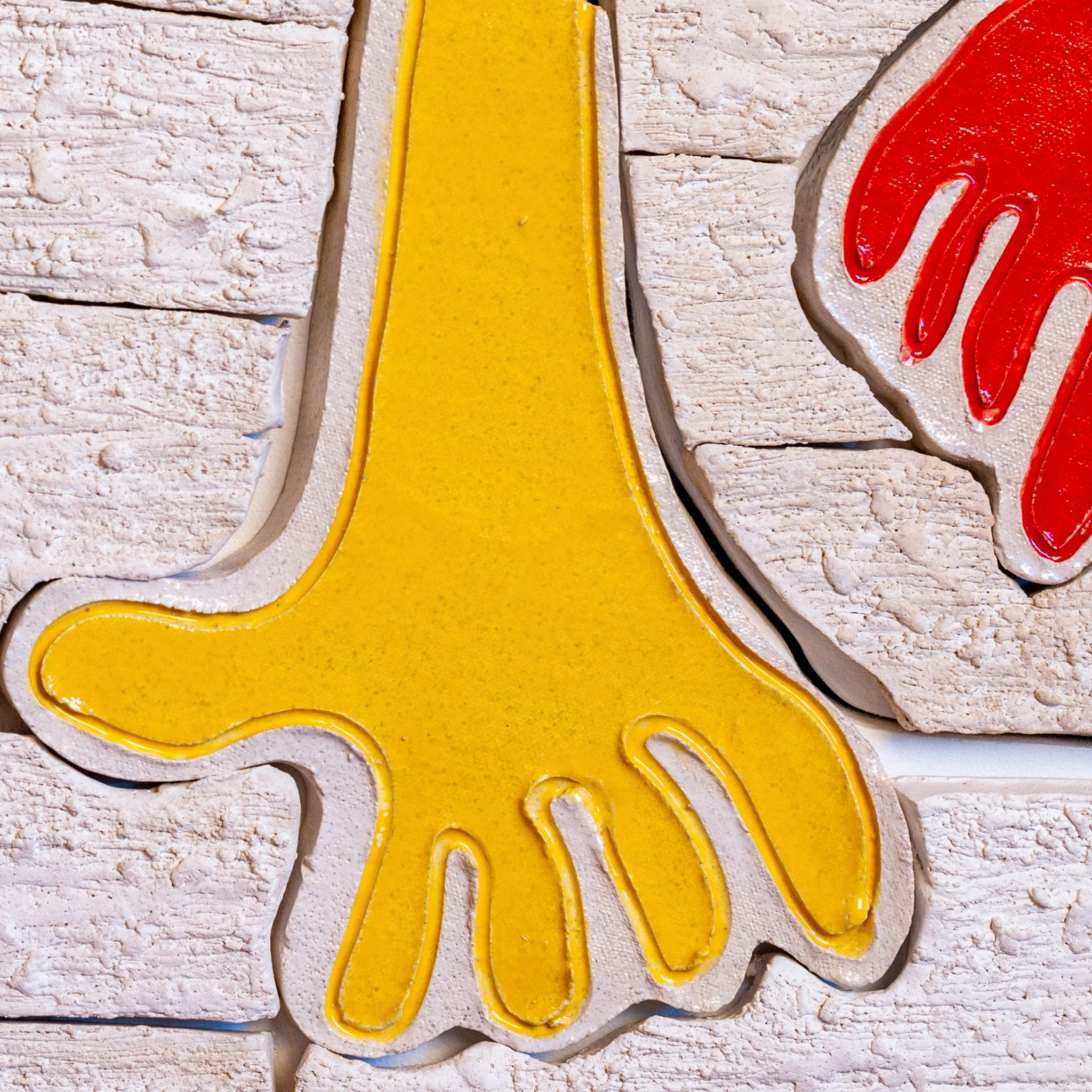 Hold It All Together Mural by Jim Schatz —yellow hand detail
