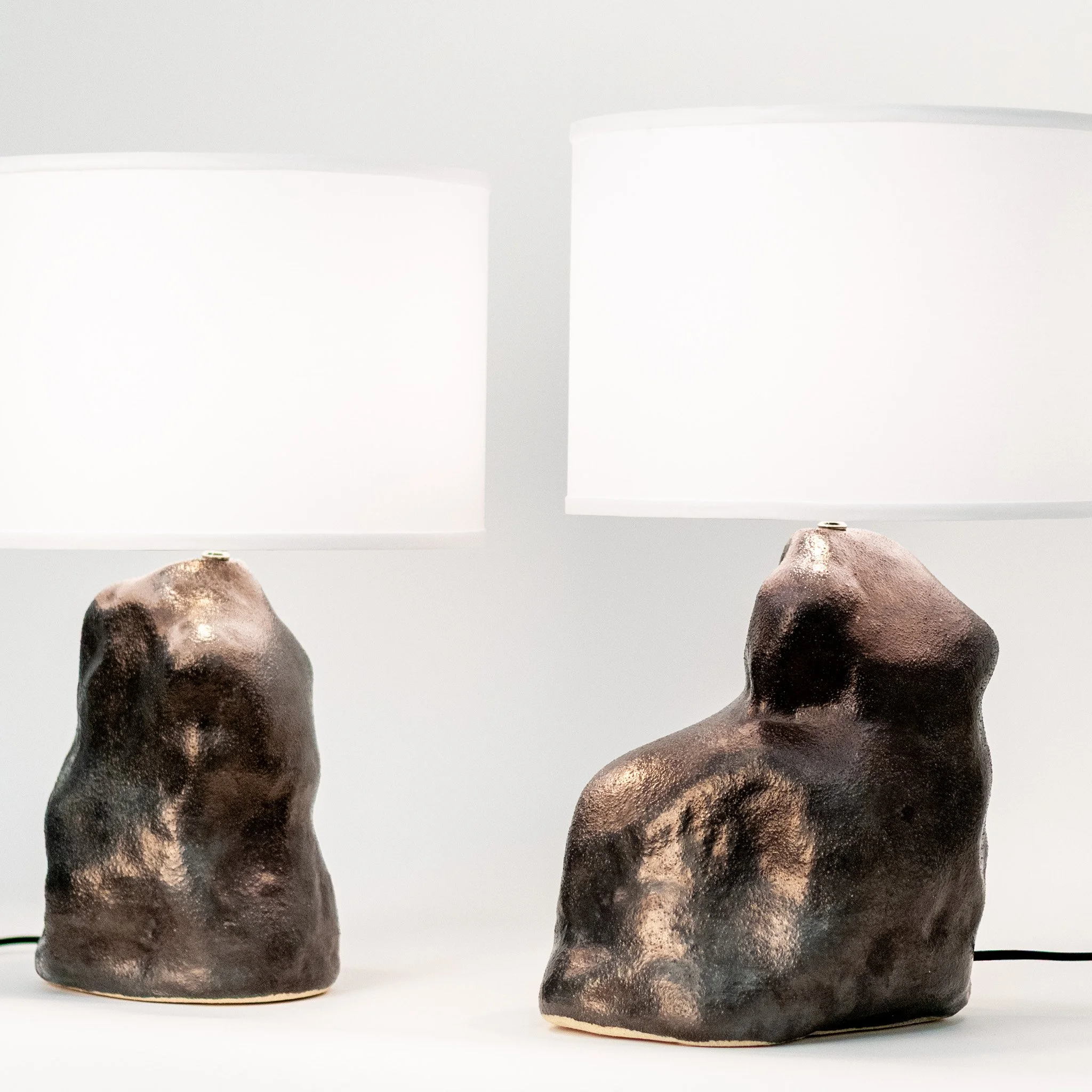 Metallic Black Amorphous Lamp Pair by Jim Schatz — front, two one-of-a-kind sculptural ceramic lamps with linen shades