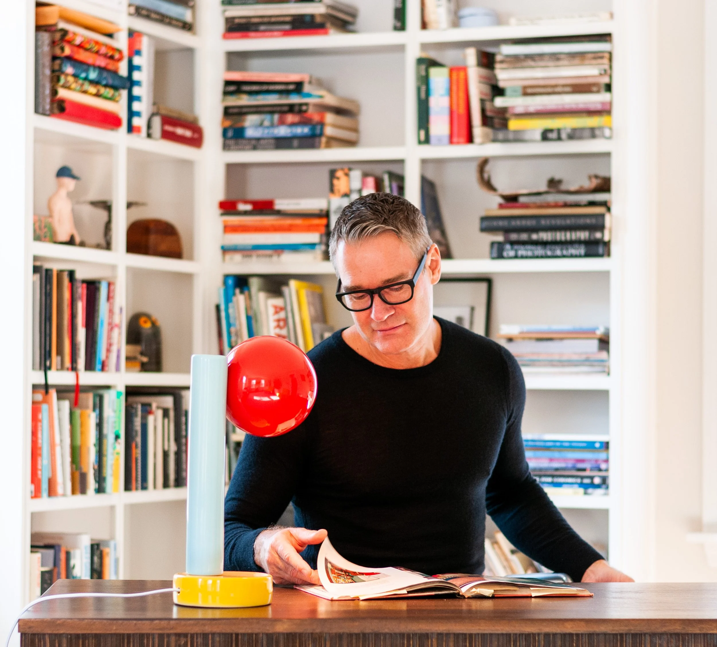 Jim Schatz at his desk with the Spot On Desk Lamp by J Schatz Studio