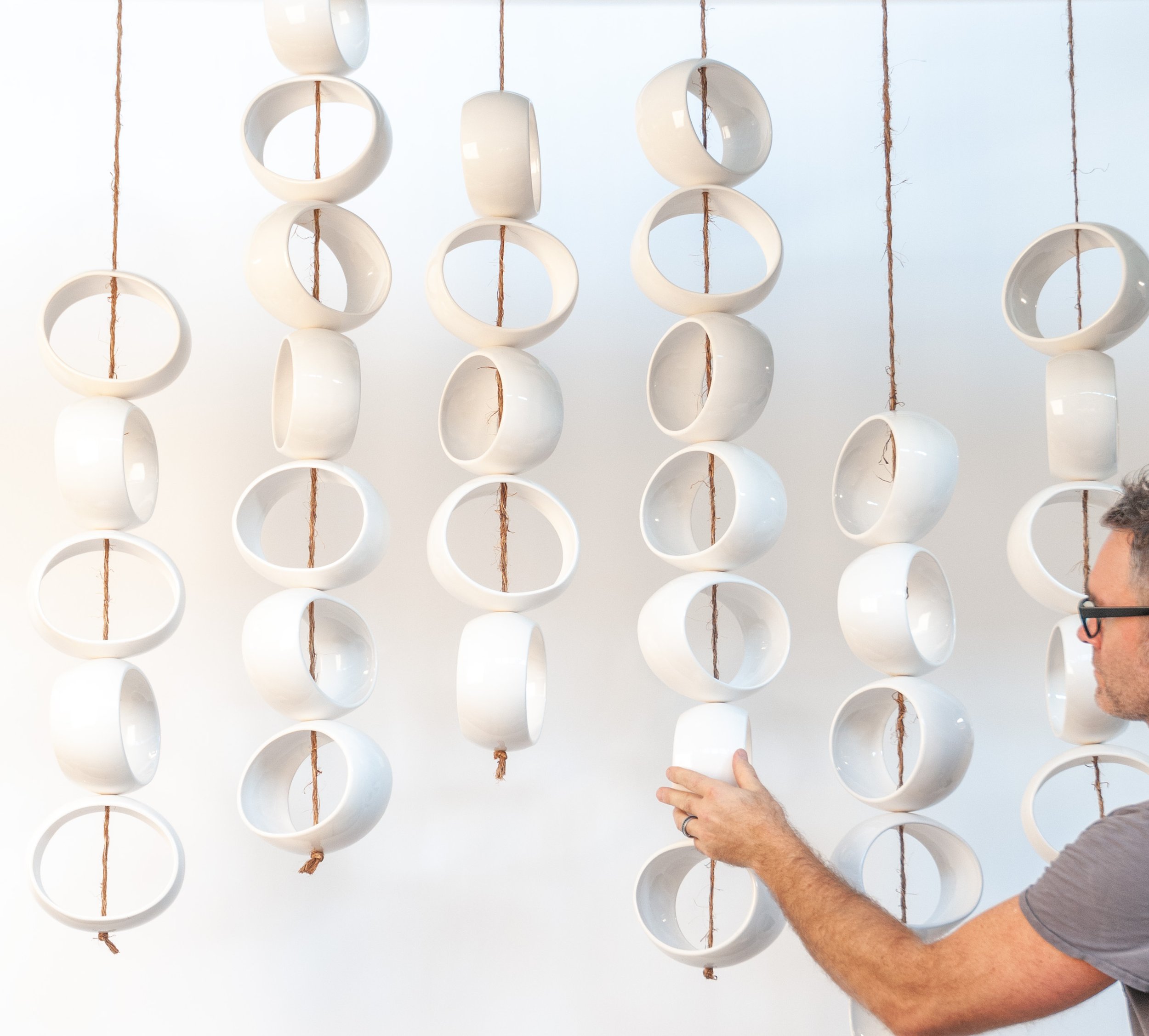 Jim Schatz with Orb Sculpture, ceramic installation by J Schatz Studio