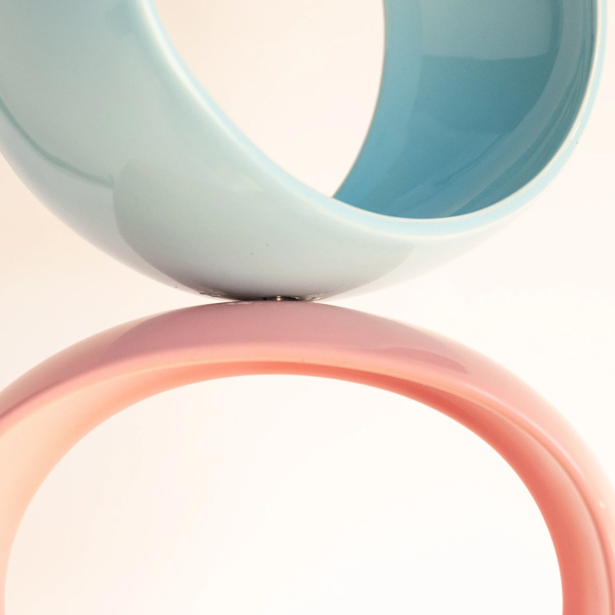 Stainless steel grommet detail connecting two orbs