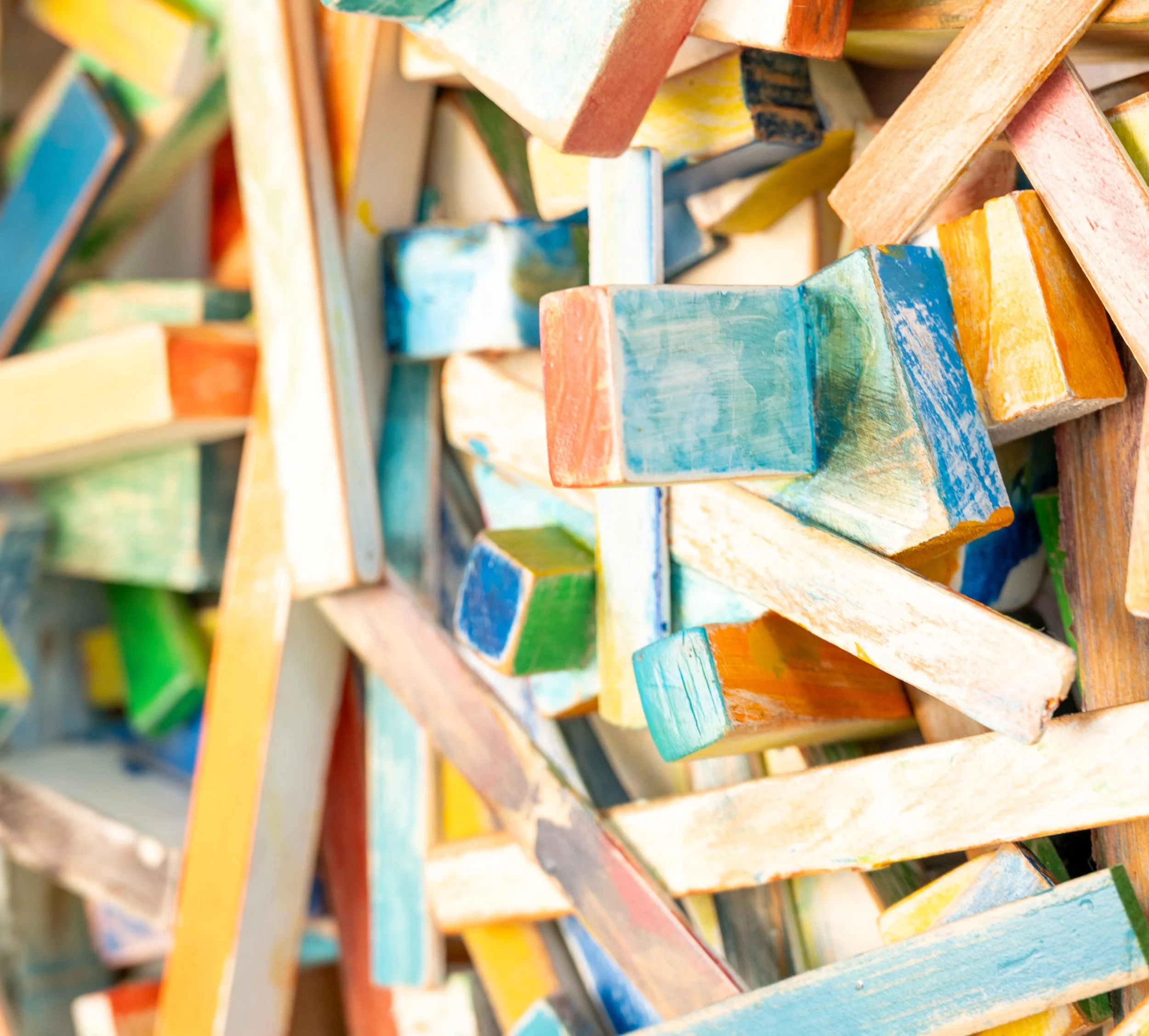 Jumping to Conclusions, detail view showing painted wood blocks and strips crossing in relief