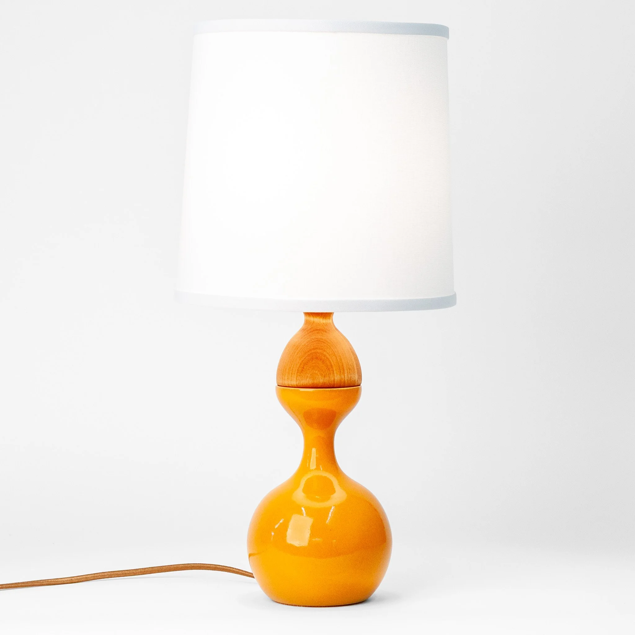 Kuni Juu Table Lamp Small in Orange Peel by Jim Schatz with J Schatz Studio — front, speckled stoneware base with hand-spun alder top