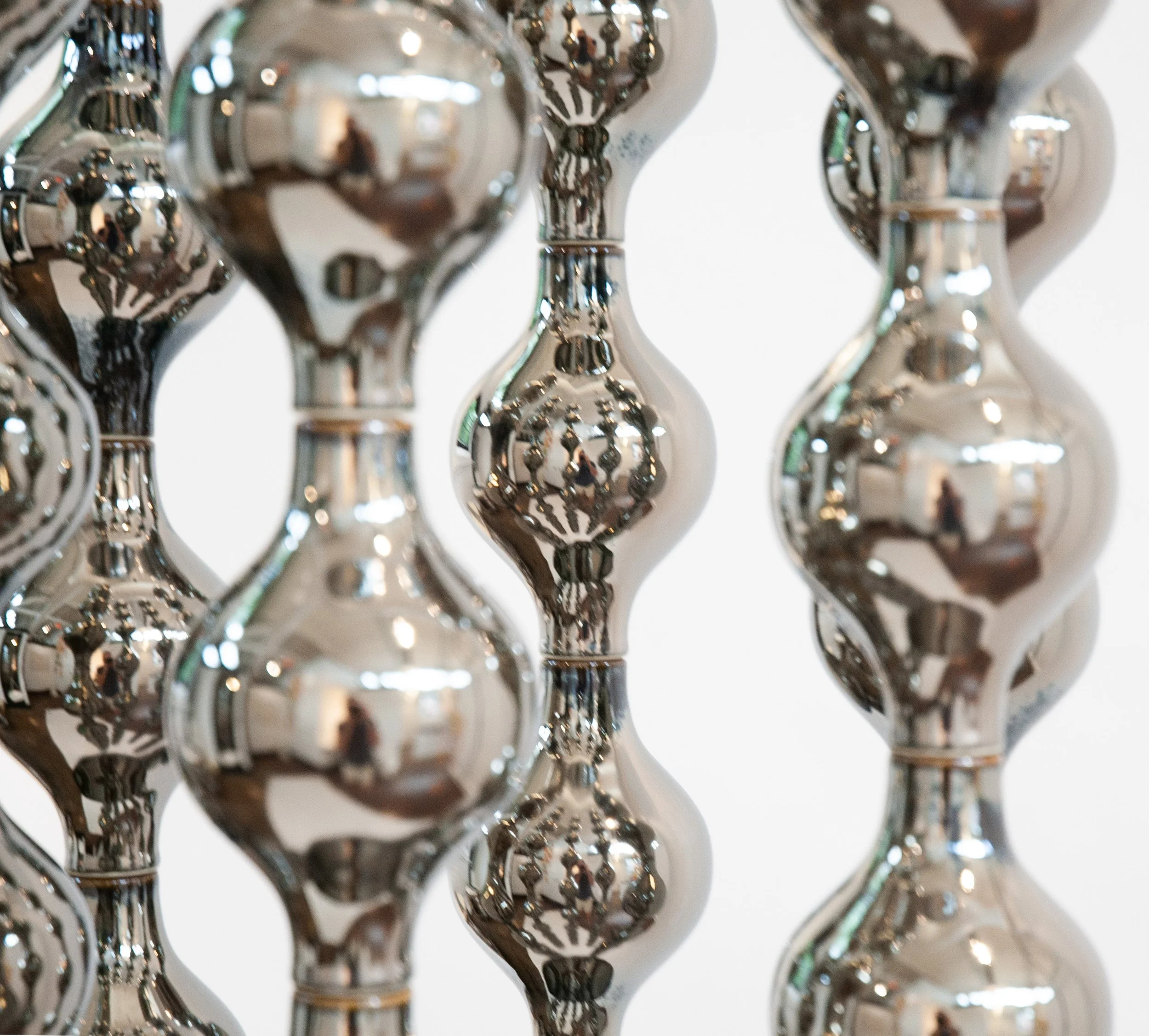 Adjacent platinum-glazed columns of Happening Circle, ceramic detail
