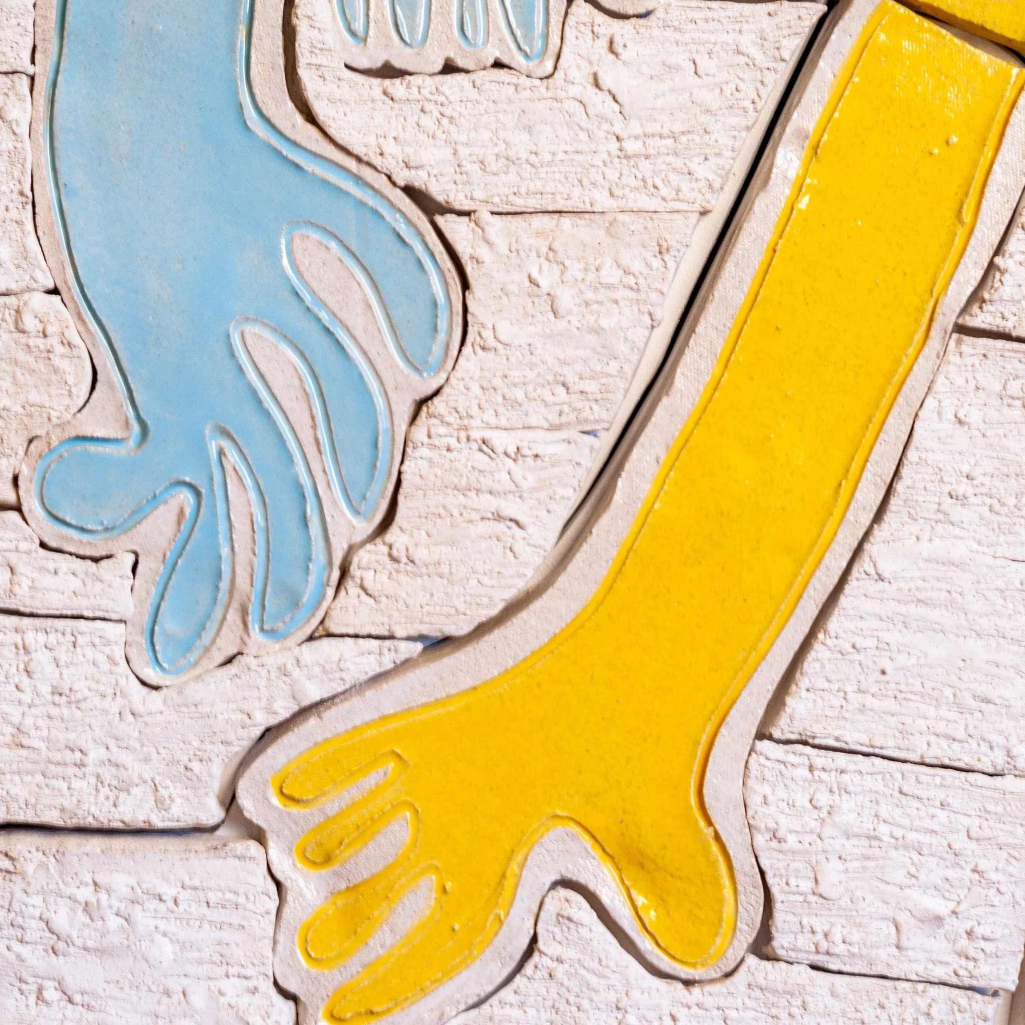 Hold It All Together Mural by Jim Schatz — yellow and blue hand detail