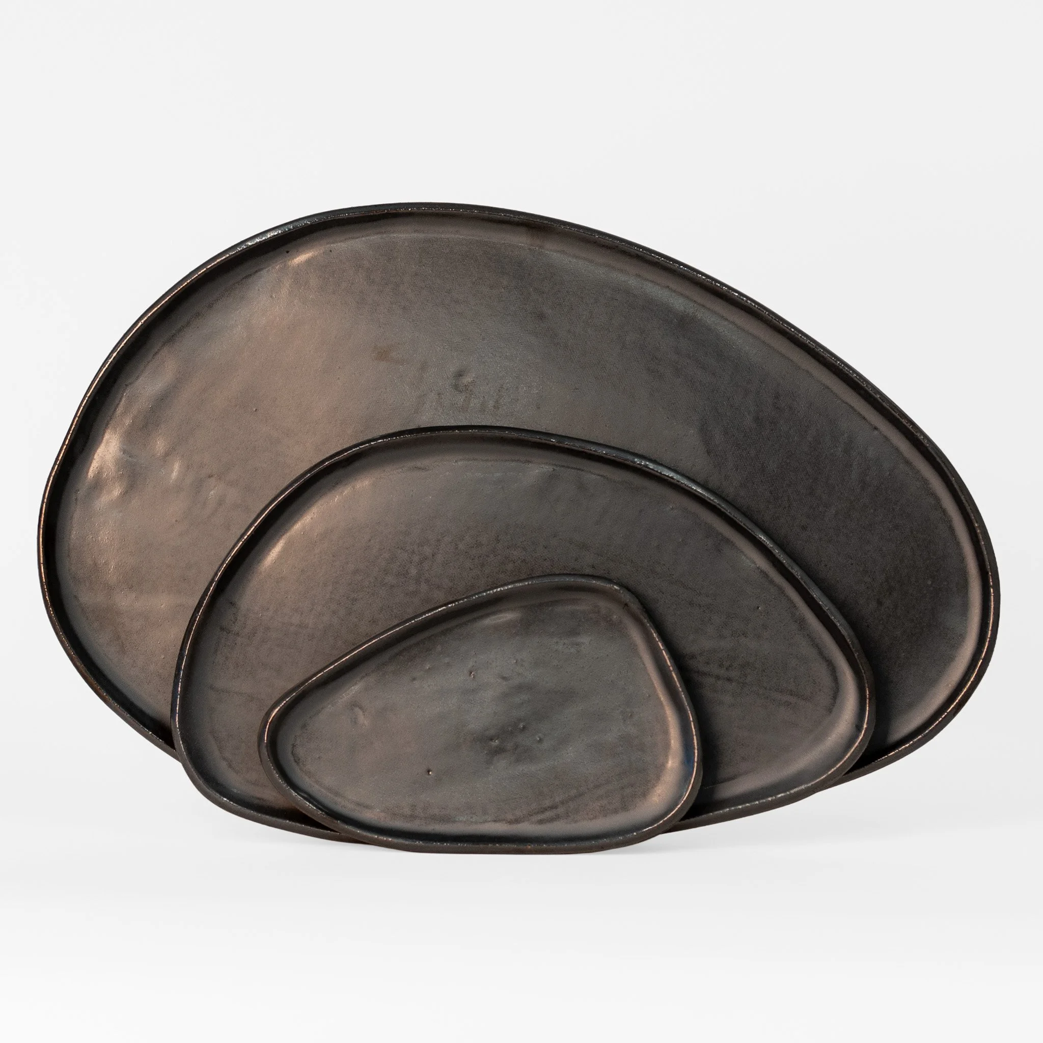 Amorphous Platter Sets, two colorways of slab-built stoneware platters by Jim Schatz