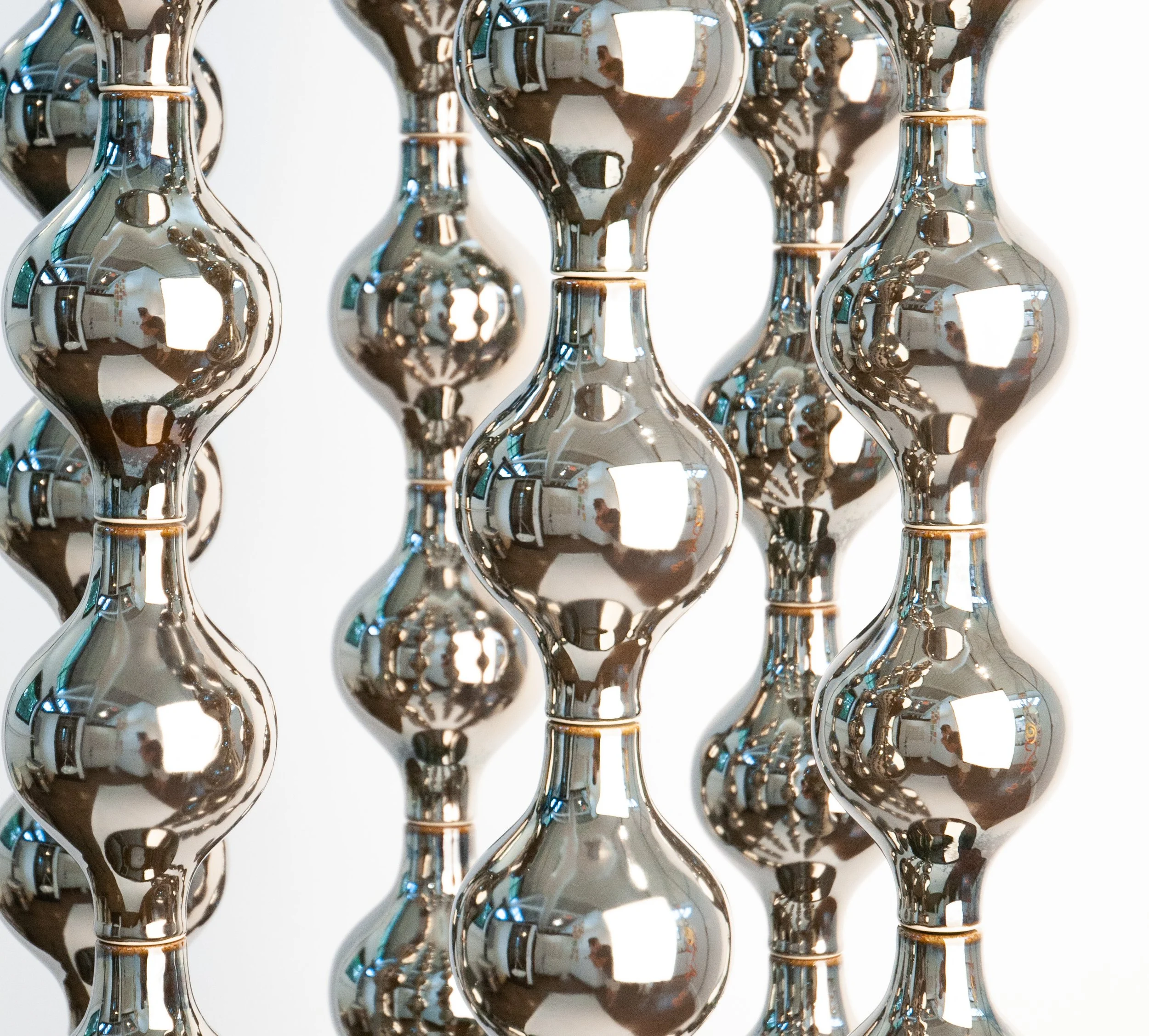 Multiple platinum-glazed stoneware columns of Happening Circle in close view