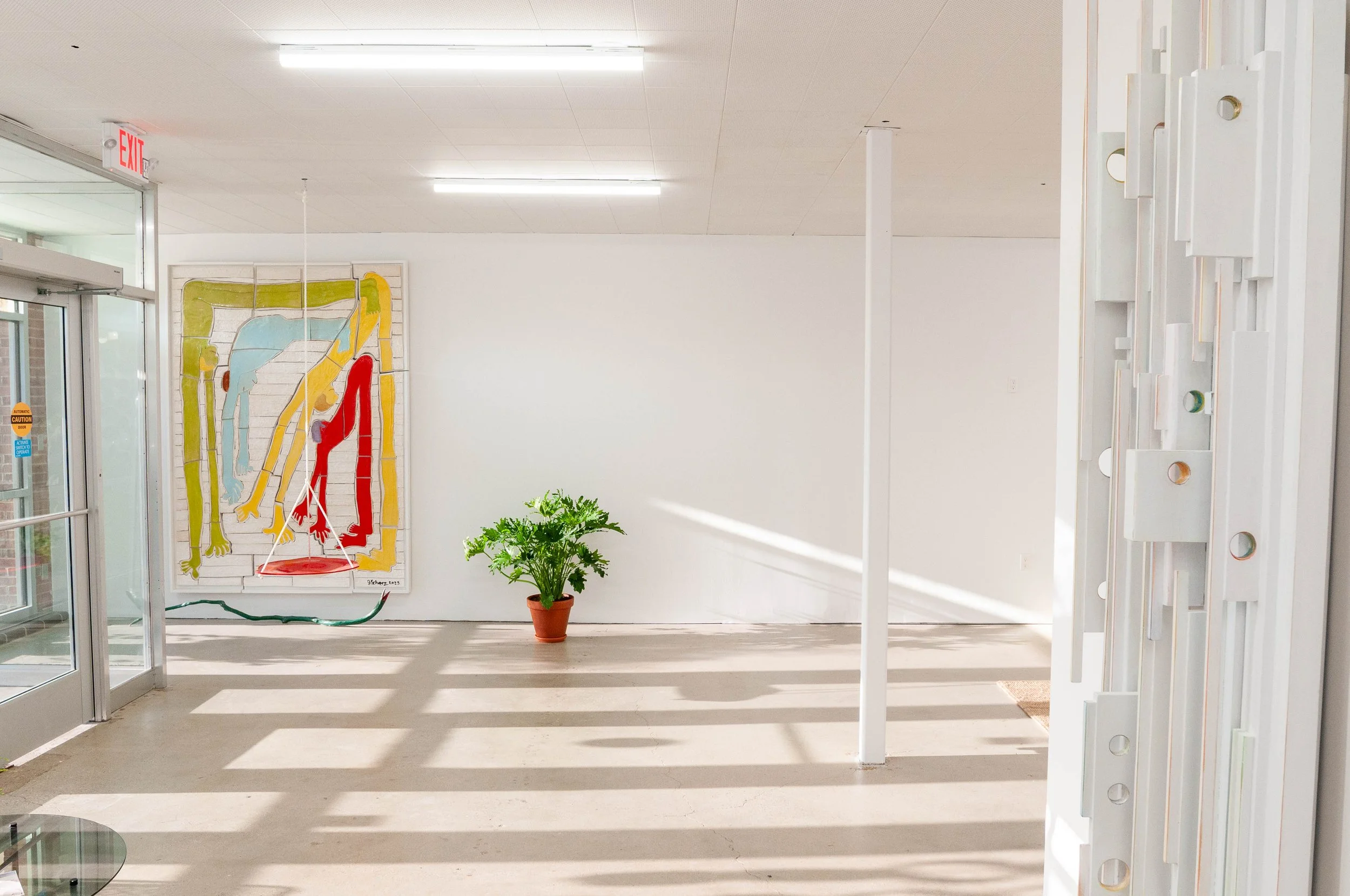 Interior of Studios Van Dyke, the studio where Jim Schatz and Peter Souza Jr. work, with A Path to the Other Side in the foreground, the Hold It All Together mural framed on the wall.