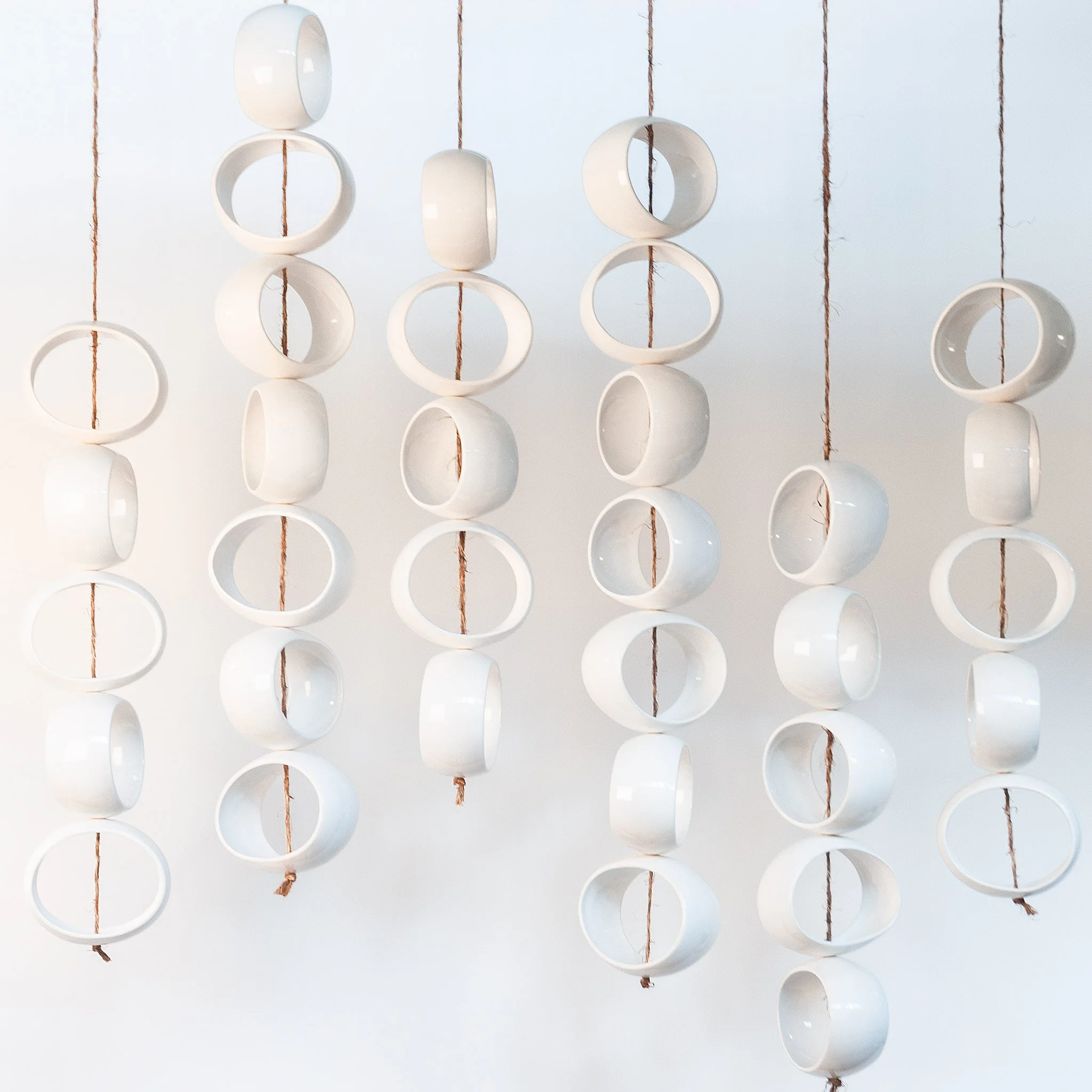 White Orb Sculpture by Jim Schatz — suspended composition of 34 stoneware orbs on hand-knotted jute rope, full view