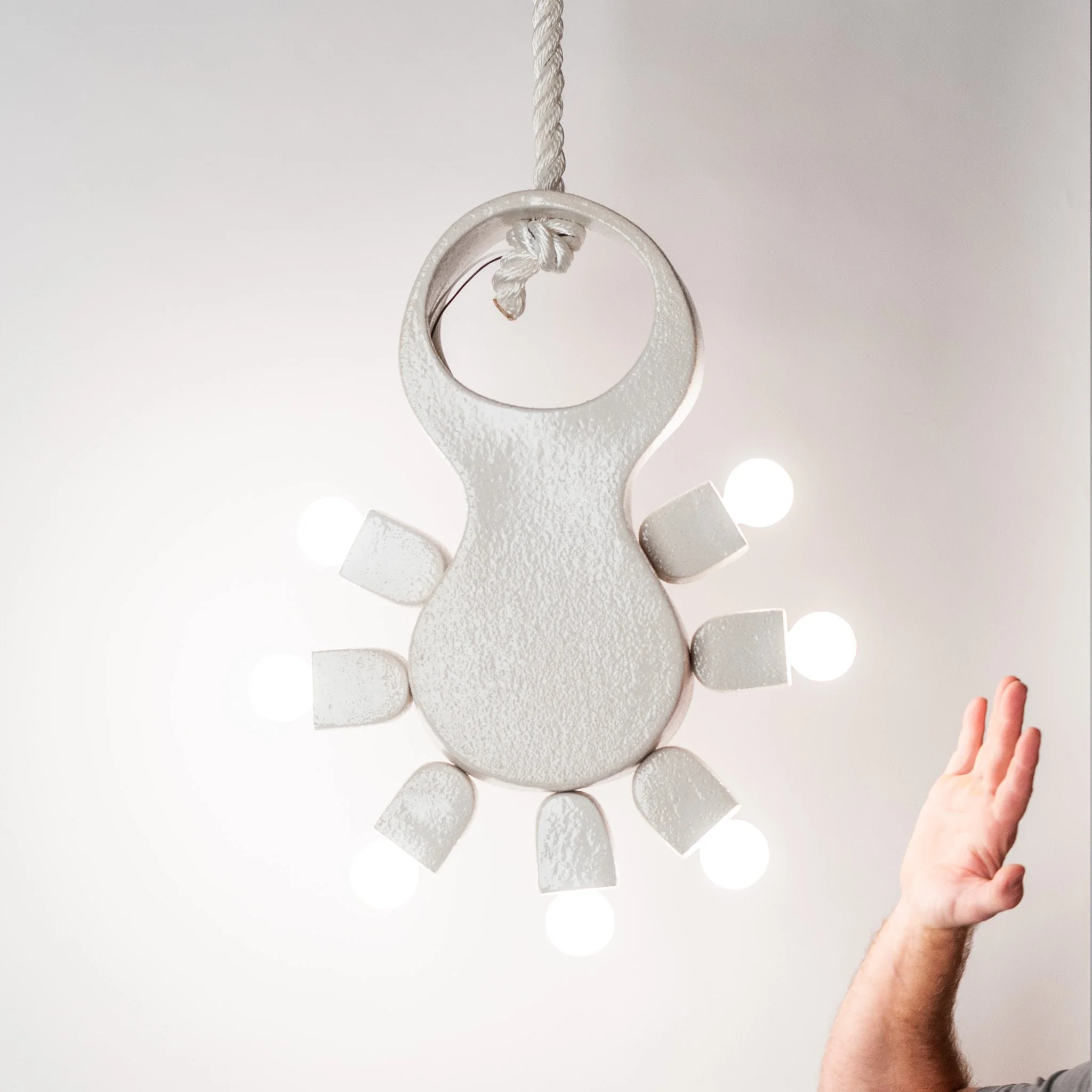Cactus Pendant Lamp by Jim Schatz — in scale with artist hand