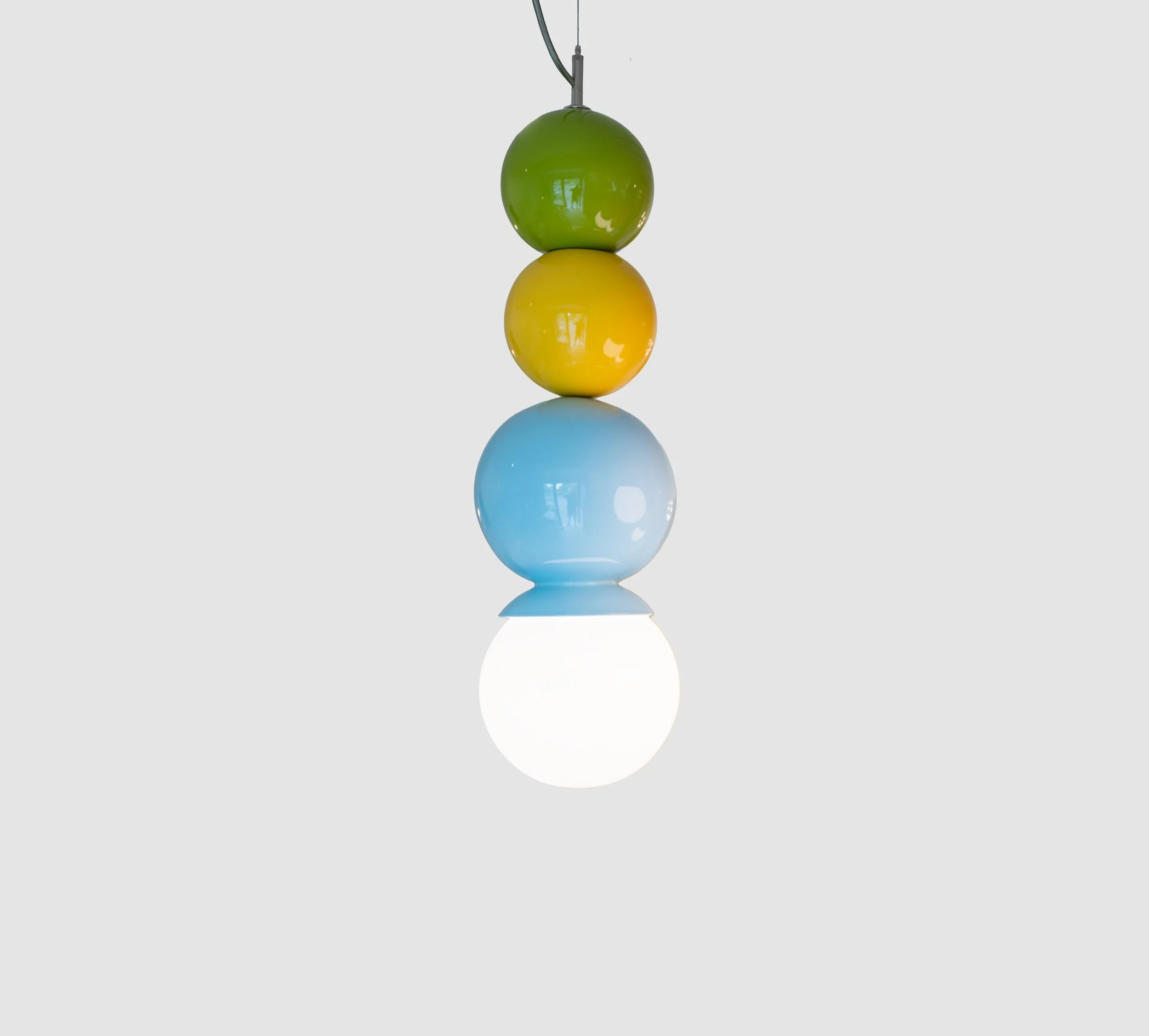 Olive, sun yellow and light aqua ceramic Dot Dot Dot pendant, three glossy spheres stacked over a lit white globe, J Schatz Studio.
