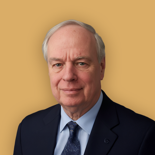 A portrait of an older man with gray hair, wearing a dark suit, light blue shirt, and patterned tie, against a beige background.