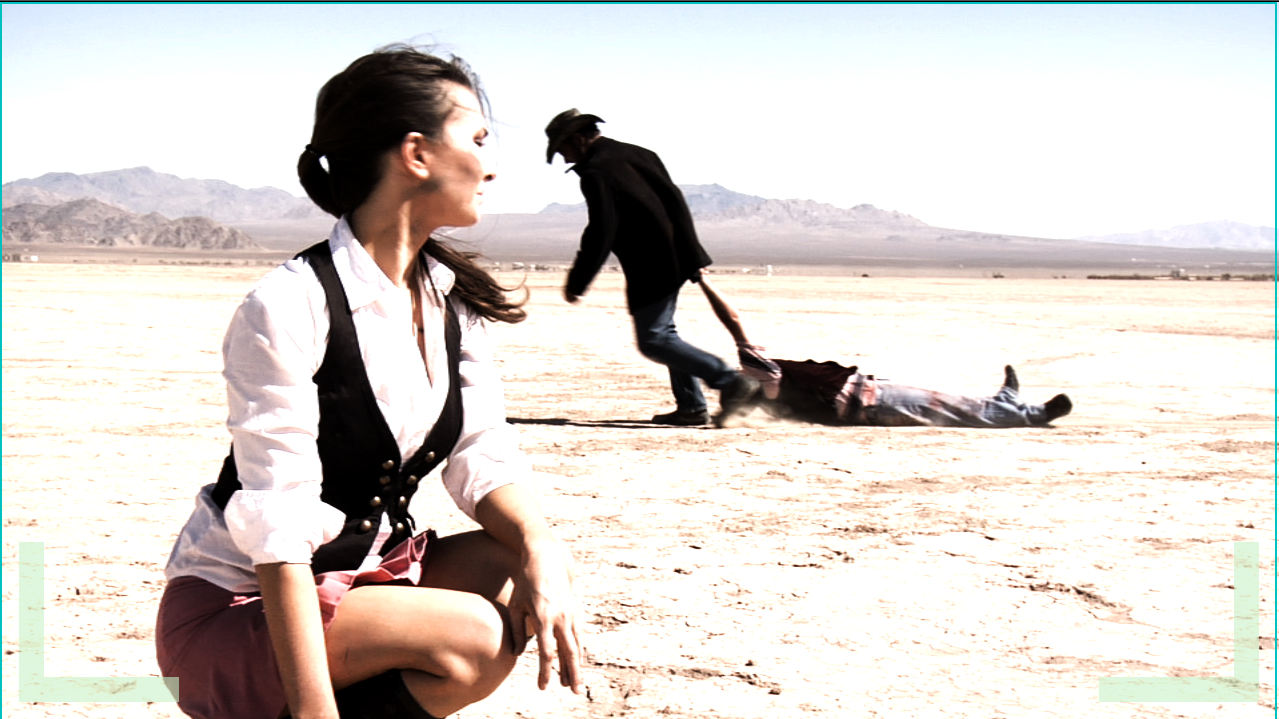 I'm directing this series from in side the film. I am standing (with Cowboy hat) in the Lucerne desert lakebed while shooting Apocalyptic Playground, A sci fi series. Actress Cooper Harris in foreground.