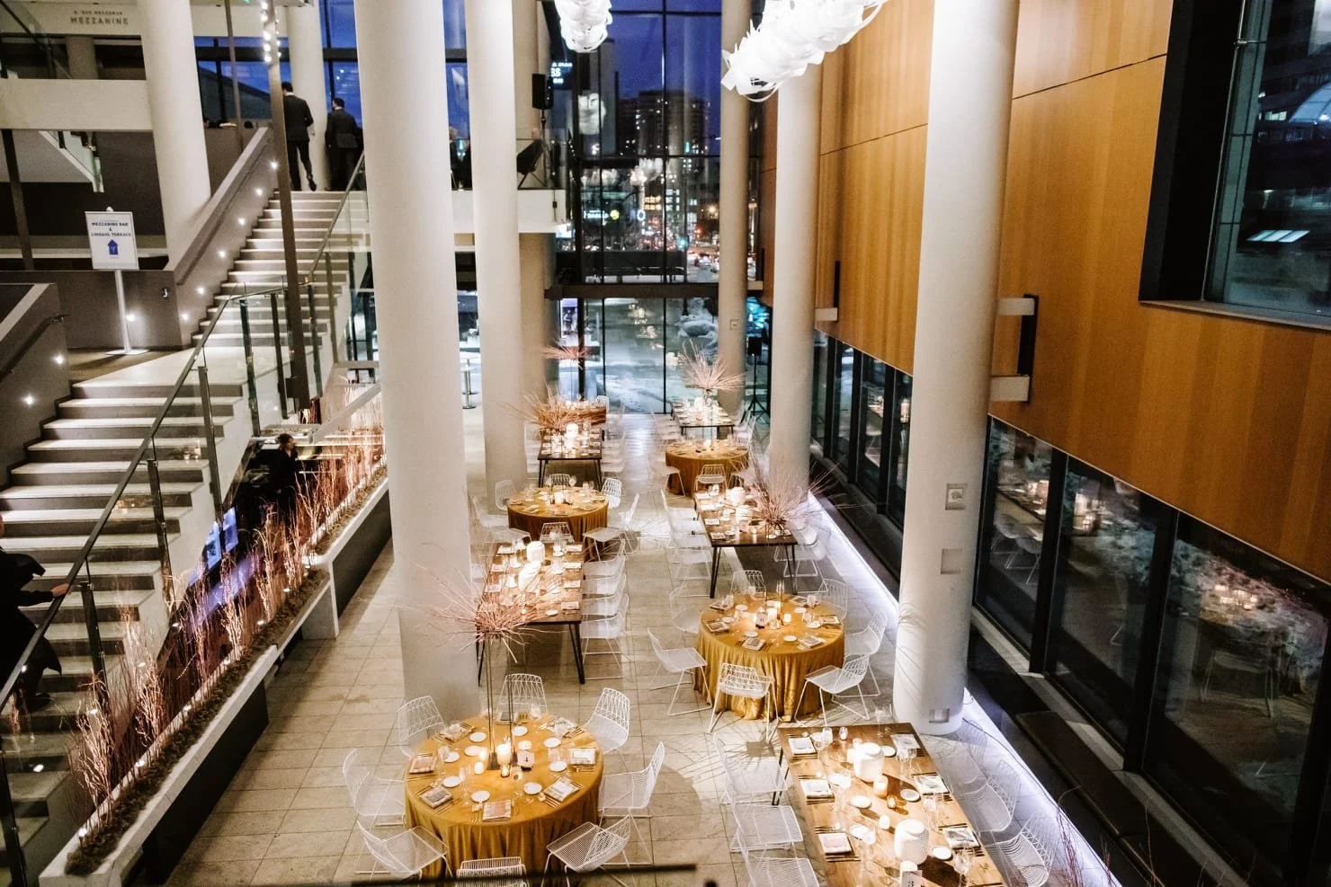 Wedding tables set with winter decor in the foyer of Orchestra Hall, one of the best winter wedding venues in Minneapolis, Minnesota