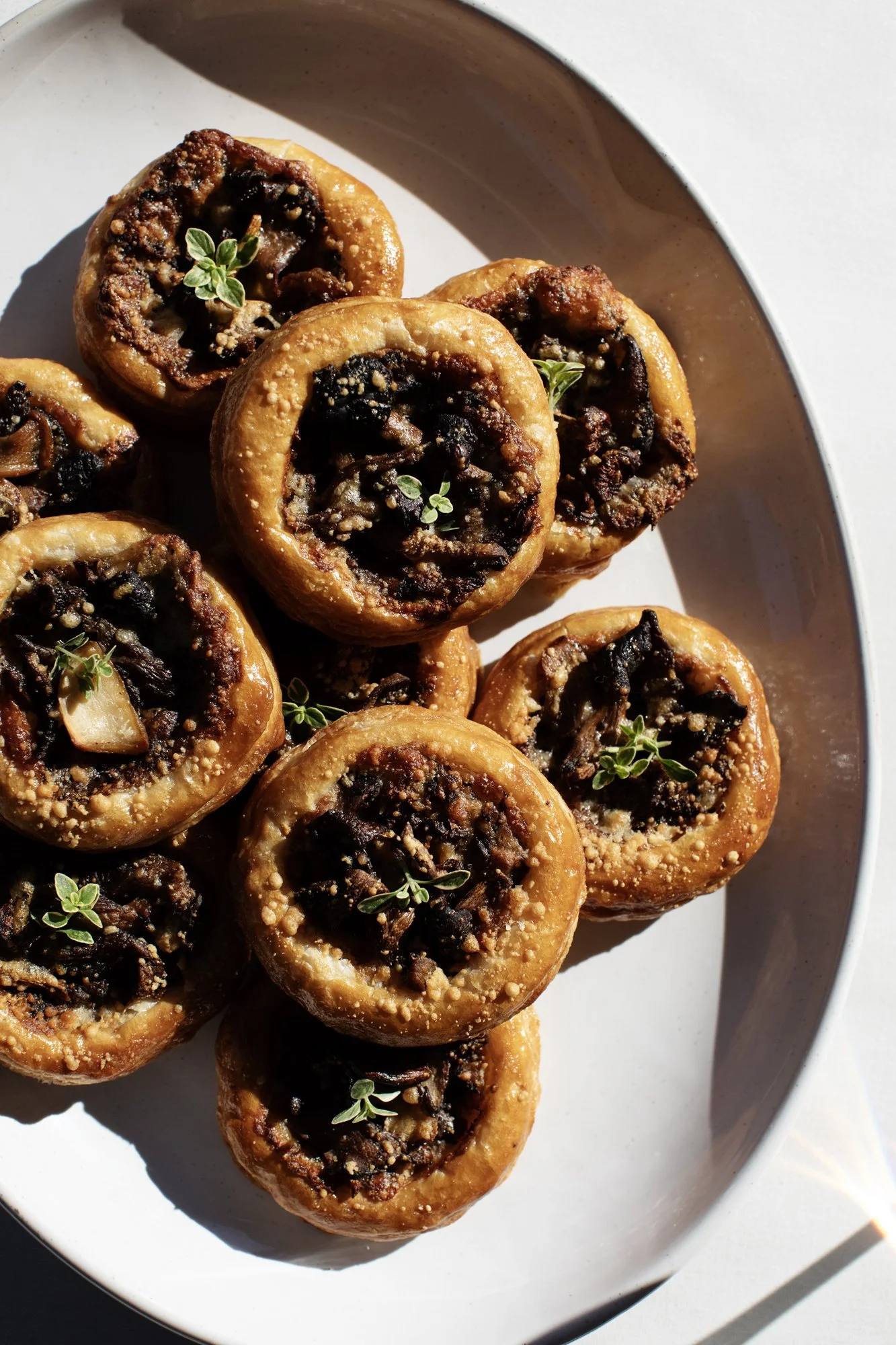 Wild mushroom tartlets with fresh thyme on a serving platter — Food Gallery Catering wedding appetizers Minneapolis
