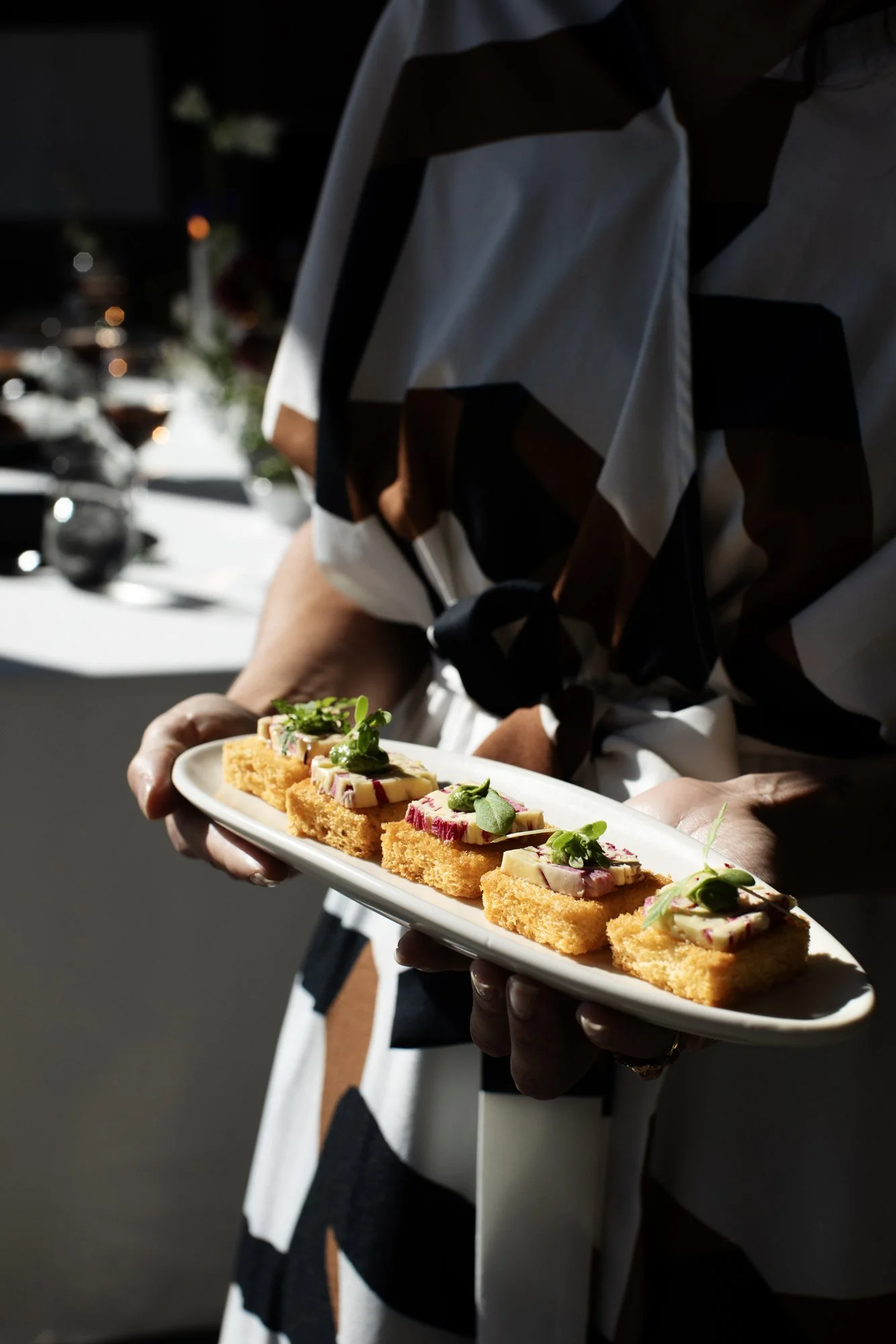 Server passing elegant passed appetizers on a tray at a wedding reception — Food Gallery Catering Minneapolis