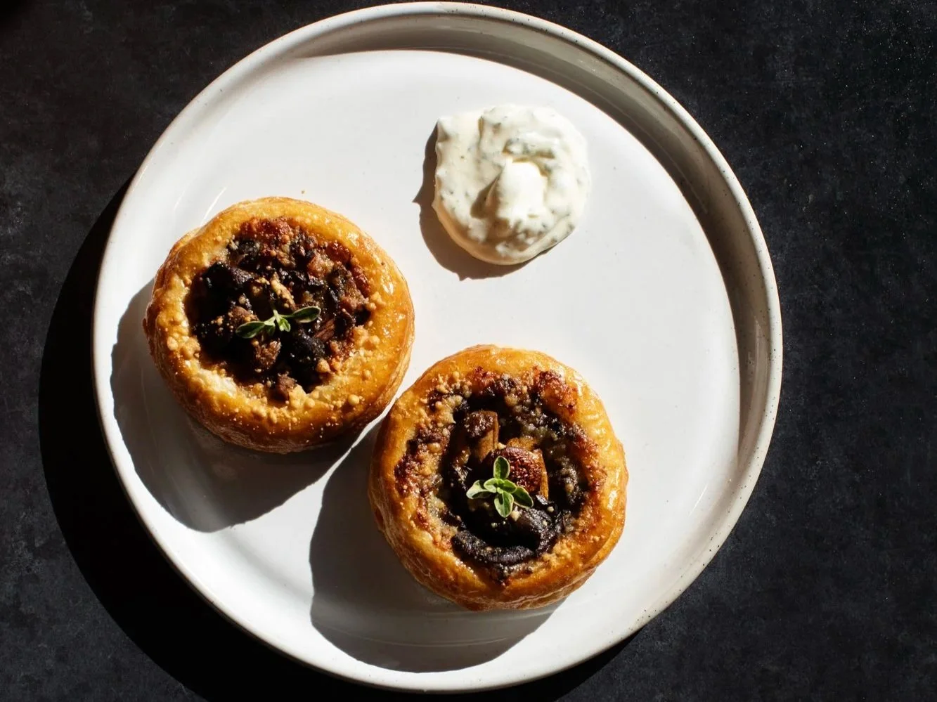 Two mushroom tartlets on a plate