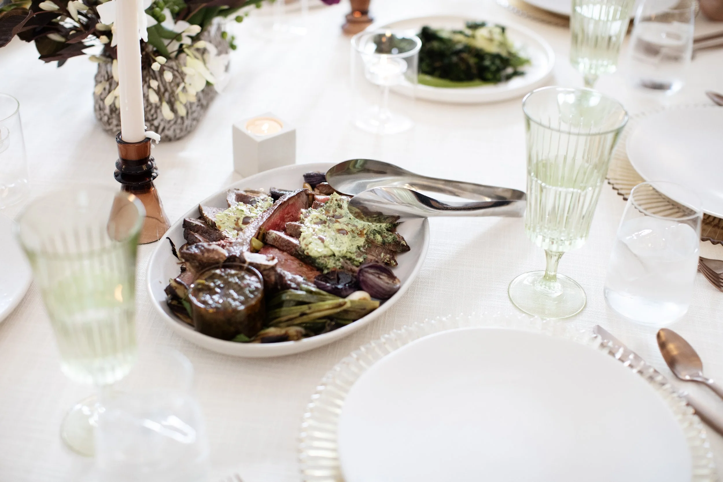 Family-style steak dish at a wedding table