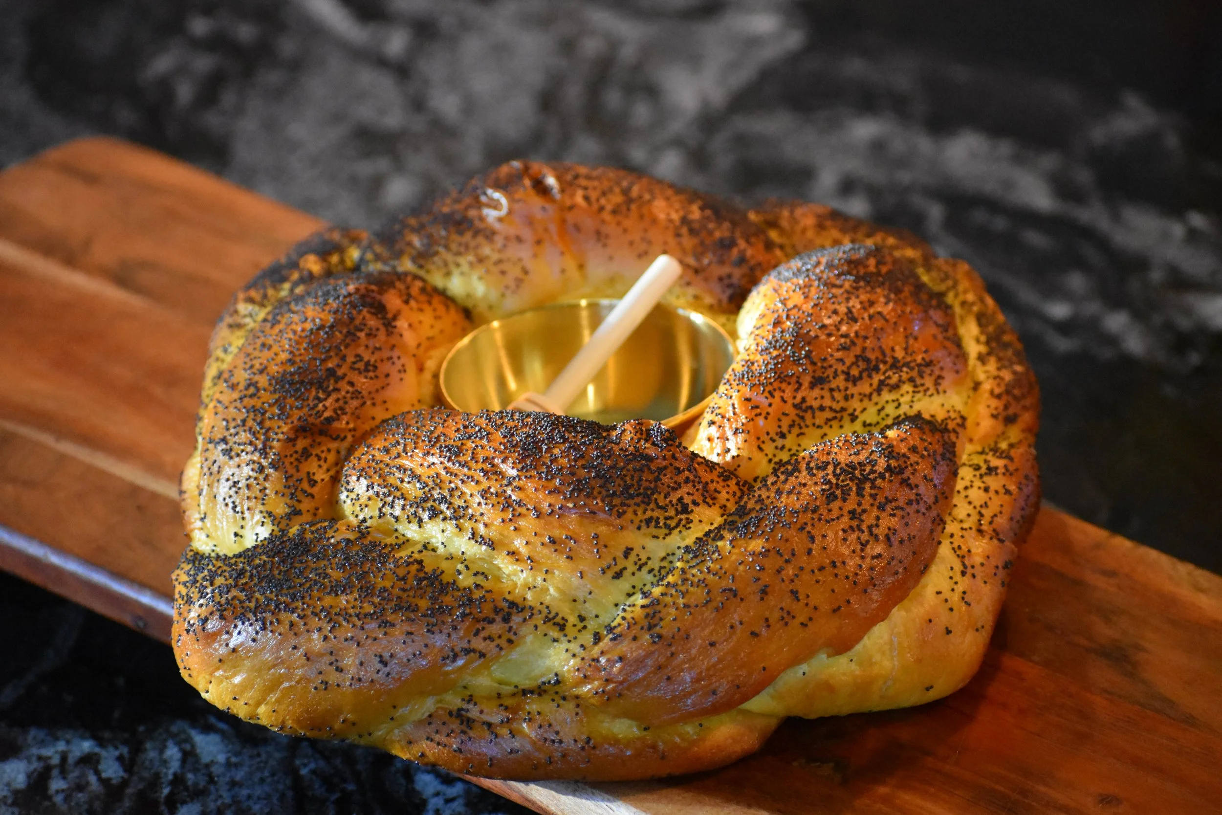 ROUND CHALLAH WITH HONEY DIPPER POPPYSEED.JPG