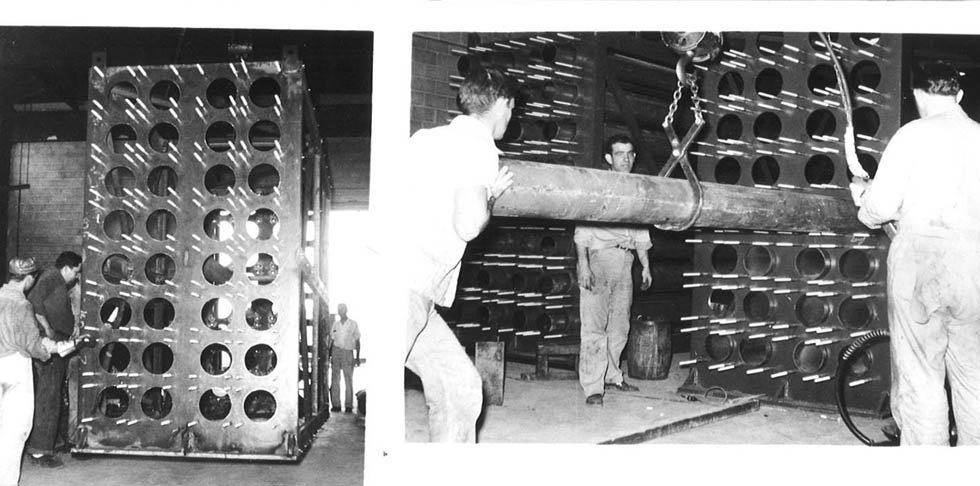 Black and white photo of workers repairing industrial heat exchanger.