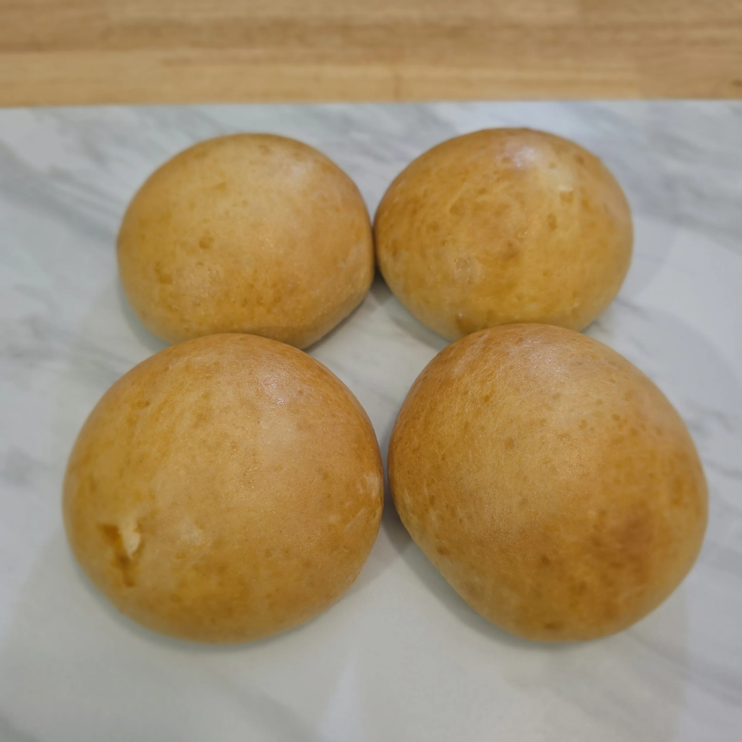 Brioche Buns: These sourdough brioche buns combine the richness of brioche with the signature tang of sourdough. Soft and fluffy, they offer the perfect texture for burgers or sandwiches.